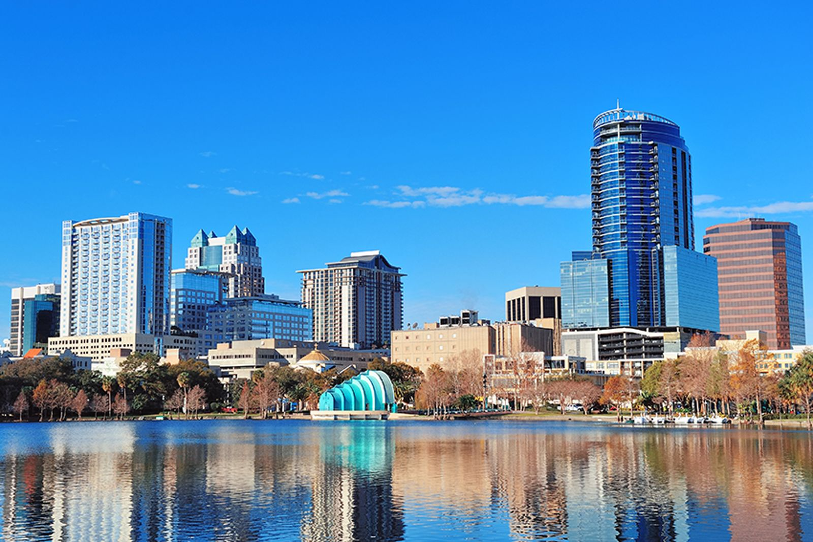 Orlando skyline reflecting off Lake Eola under a clear blue sky