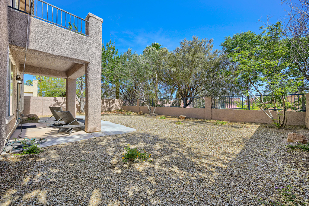 Full view of the backyard concrete patio slab against the soft beige home facade