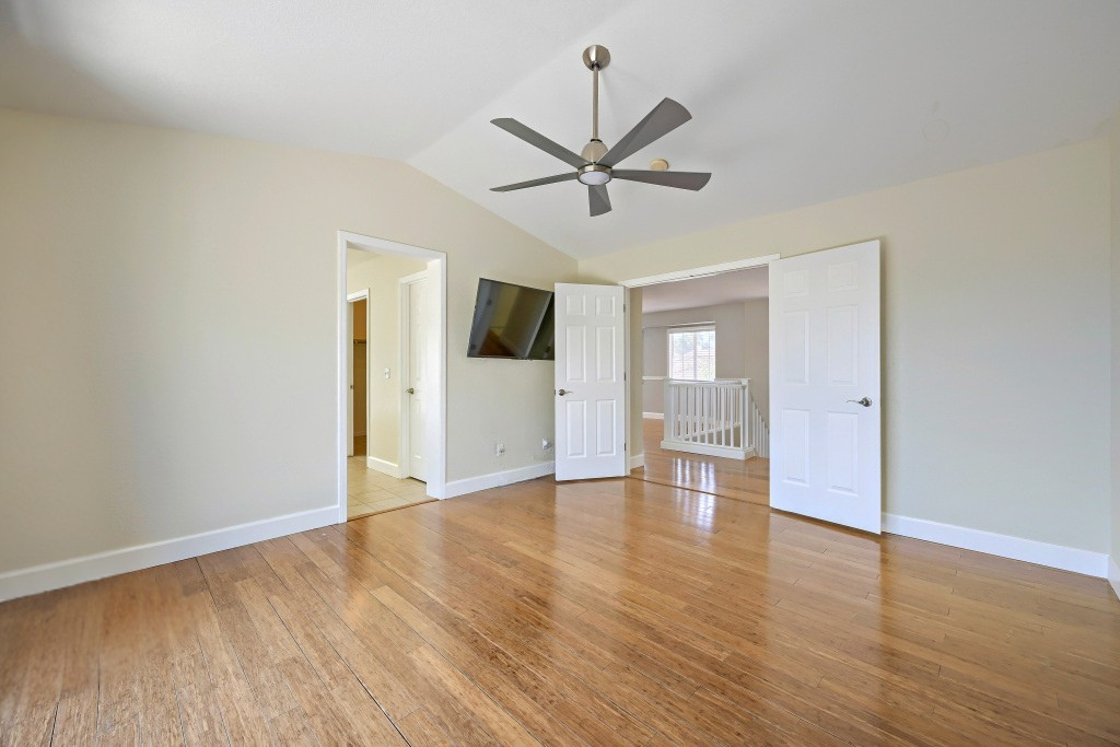 Spacious master bedroom view highlighting polished vaults and neutral walls