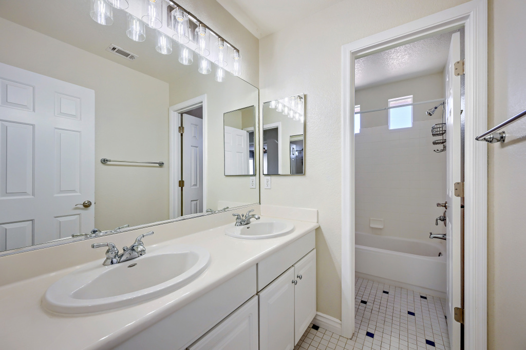 Double vanity bathroom layout with large mirror and dual sinks