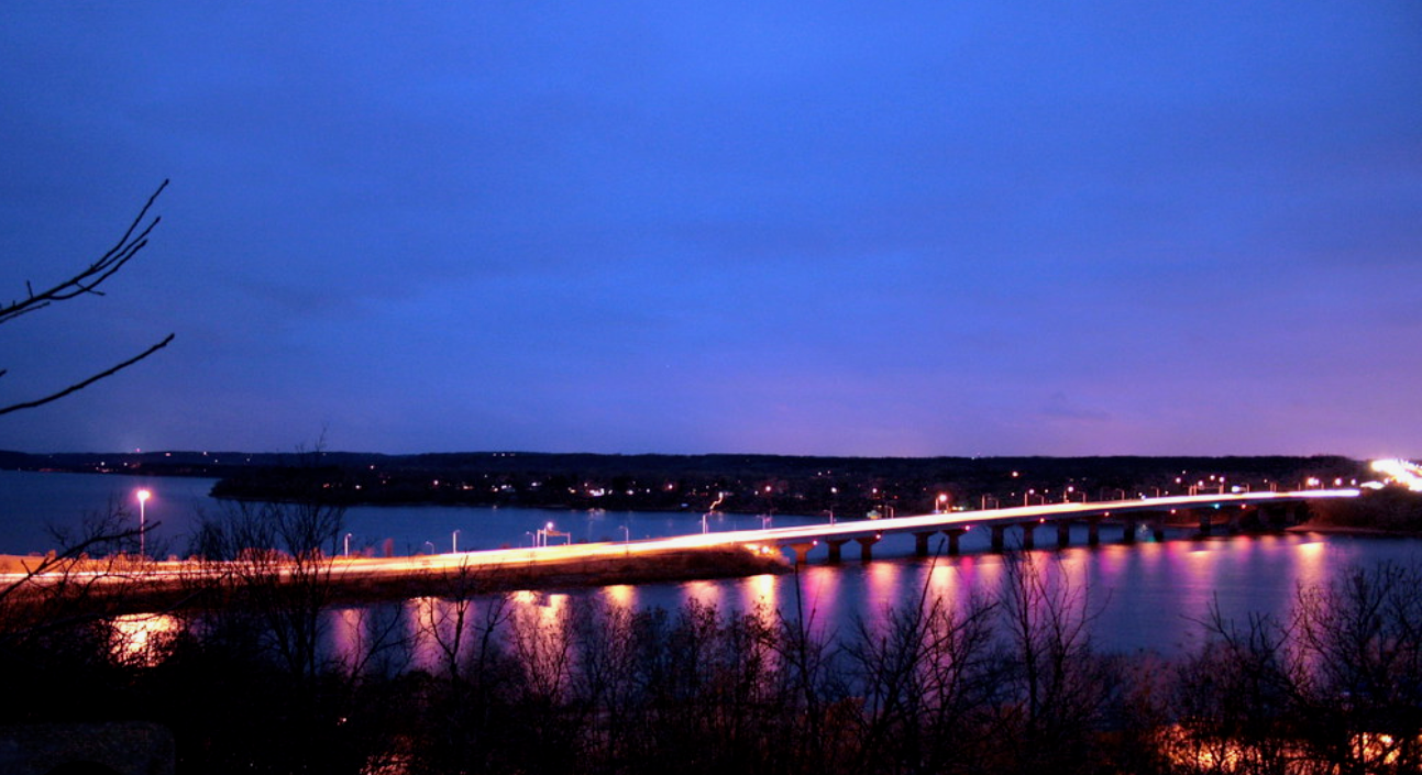 Twilight bridge crossing the St. Croix River — a signature view of the Twin Cities lake communities