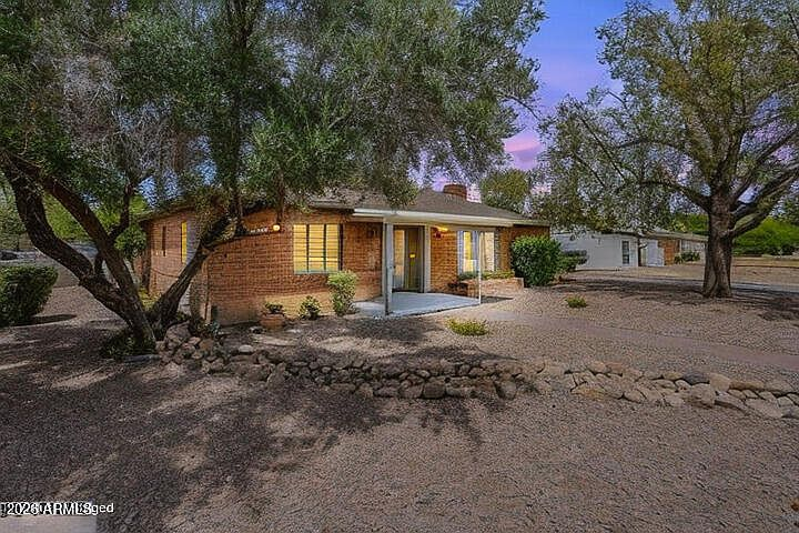1322 W FLOWER Street, mid-century red brick exterior facade at twilight