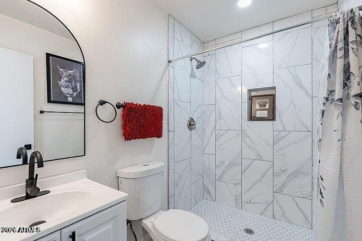 Bathroom en-suite interior featuring a modern white marble-style walk-in shower