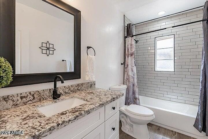 Remodeled secondary bathroom vanity and subway-tiled tub