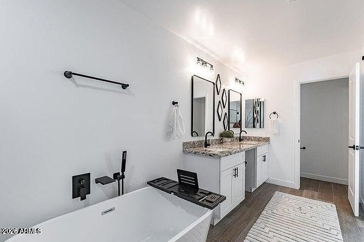 Primary bathroom soaking tub and double vanity layout