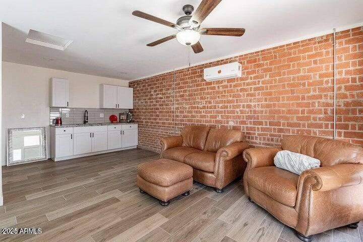 Separate 400 sqft industrial-chic studio casita with exposed red brick feature wall and kitchen