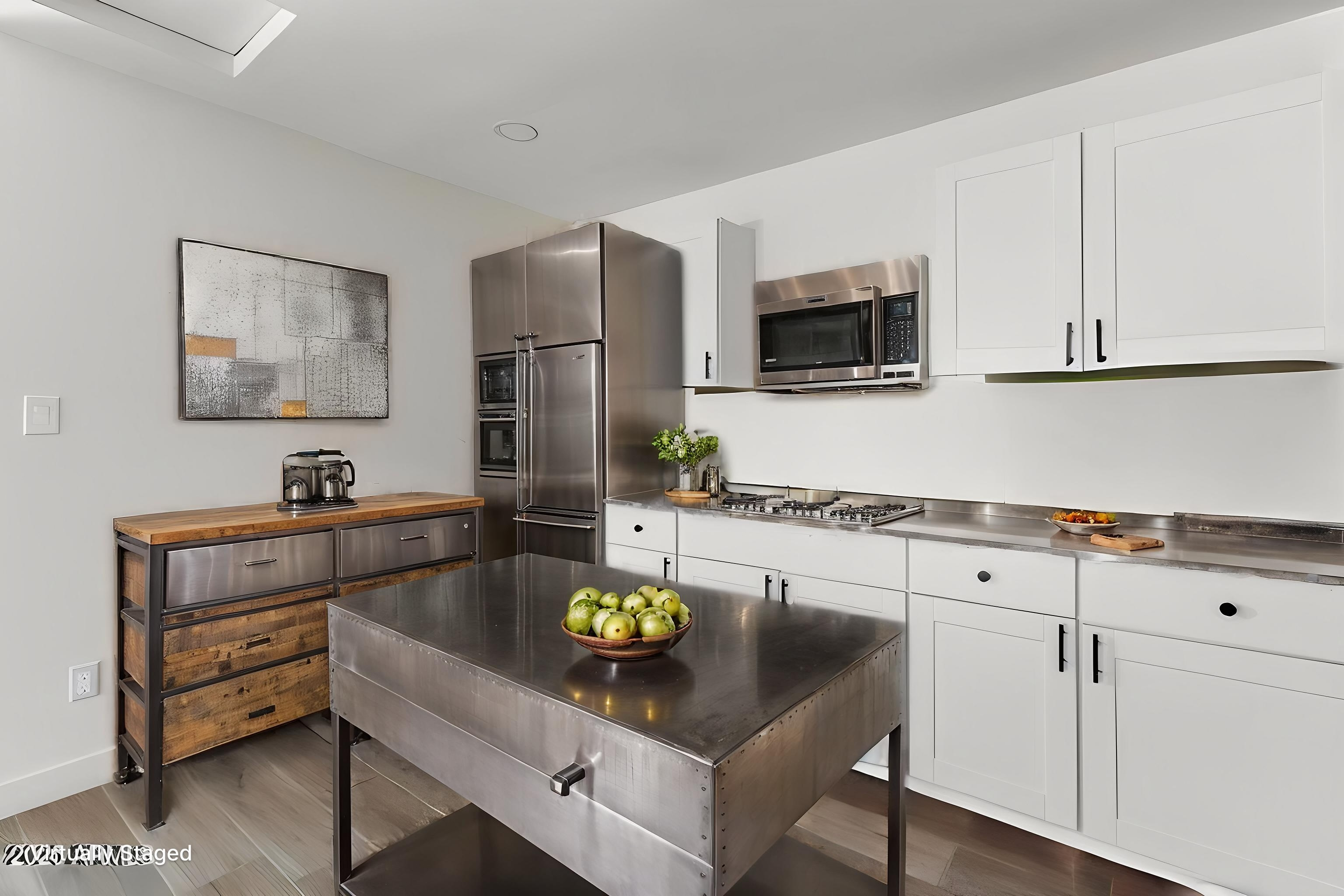 Casita industrial-chic kitchen with white cabinets and stainless steel counters