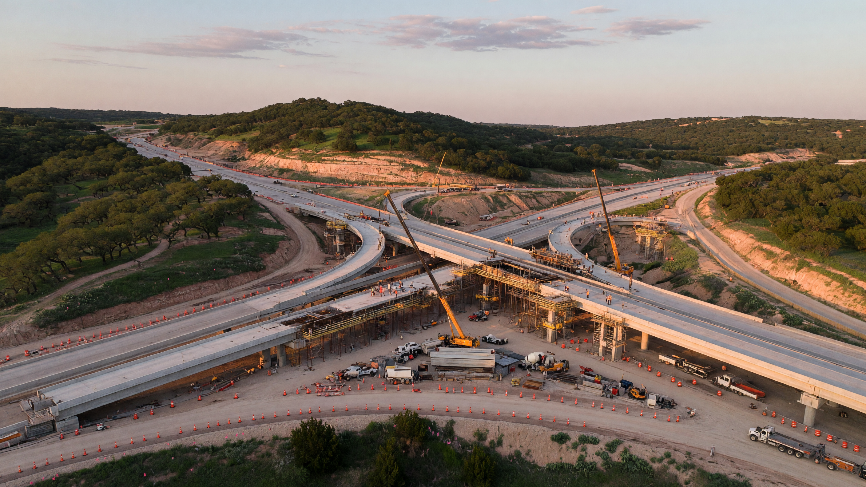 Completed modern highway corridor in north San Antonio showing smooth traffic flow on wide lanes with flyover ramps and green hillsides, representing the infrastructure results that followed the US 281 and Loop 1604 improvements