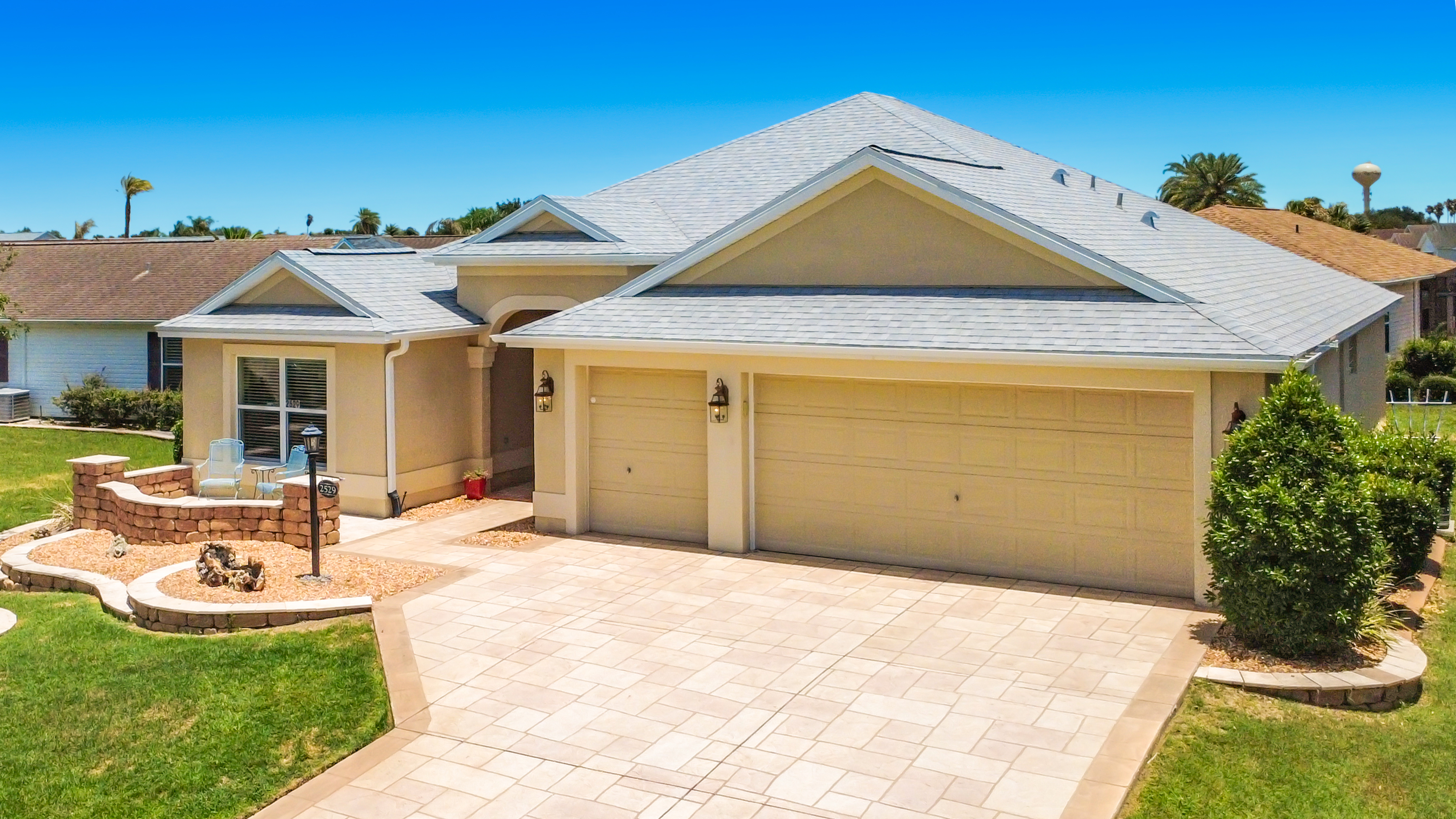 Aerial front view of 2529 Edenville Path, a turnkey 3-bedroom home in The Villages FL with paver driveway and landscaped yard