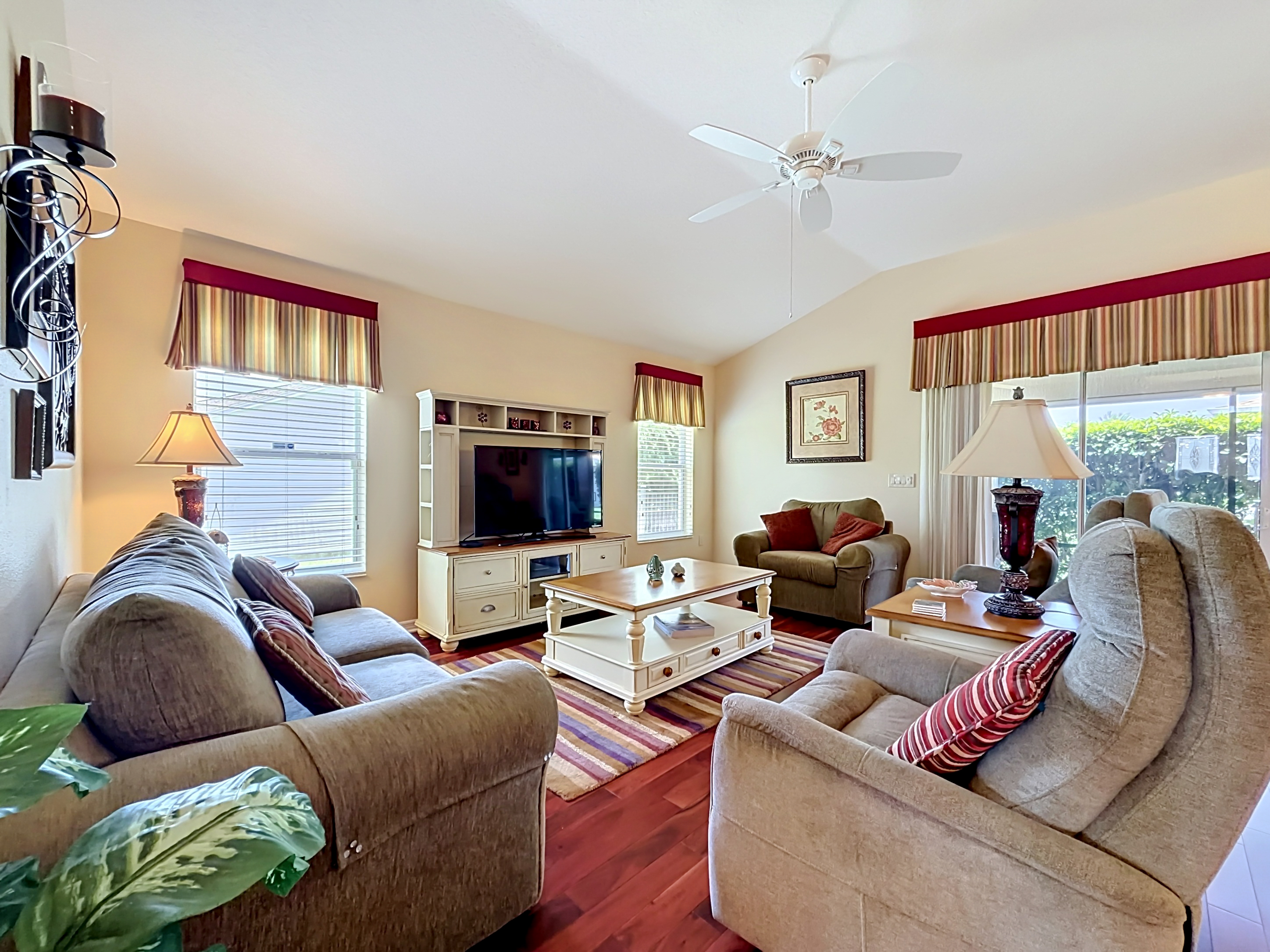 Living room wide angle with sliding glass doors to the lanai