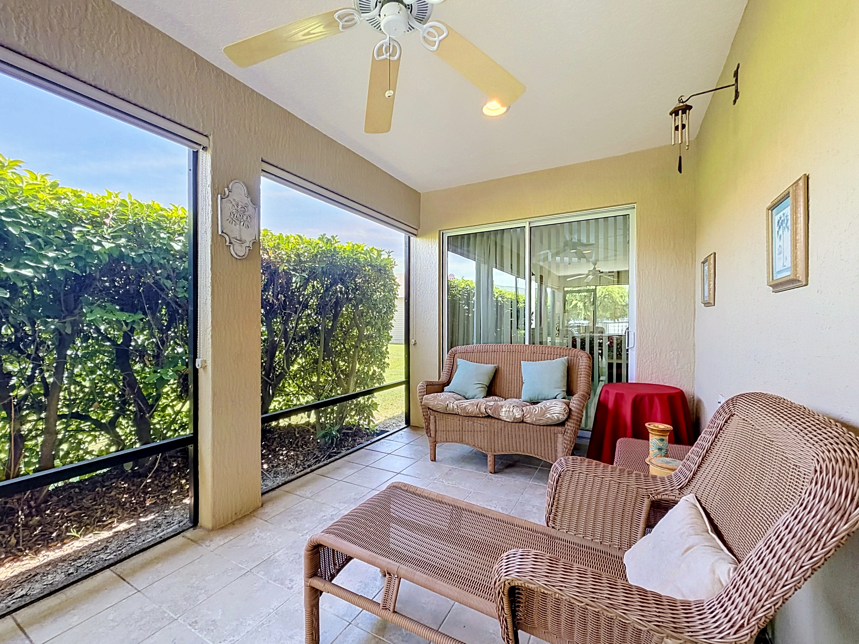 Screened back porch with dining set and ceiling fans