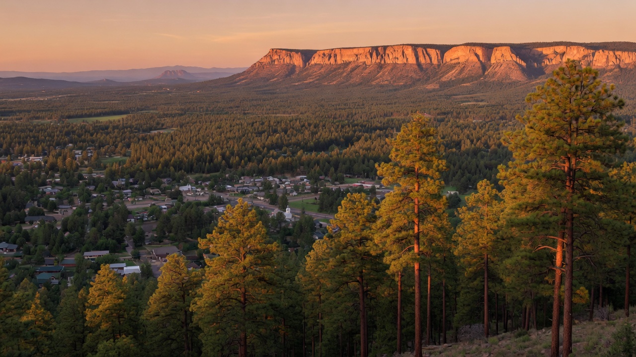 Golden hour landscape view of Payson, Arizona nestled among Ponderosa pine forests with the Mogollon Rim in the background