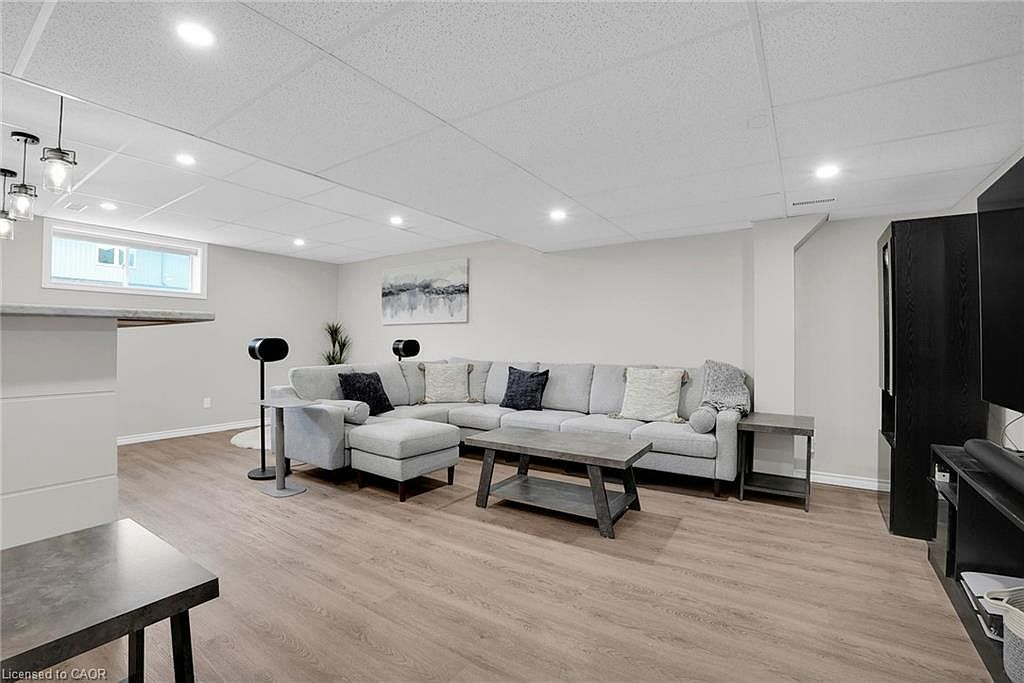 Finished basement entertainment space with wet bar at 31 Townsend Dr