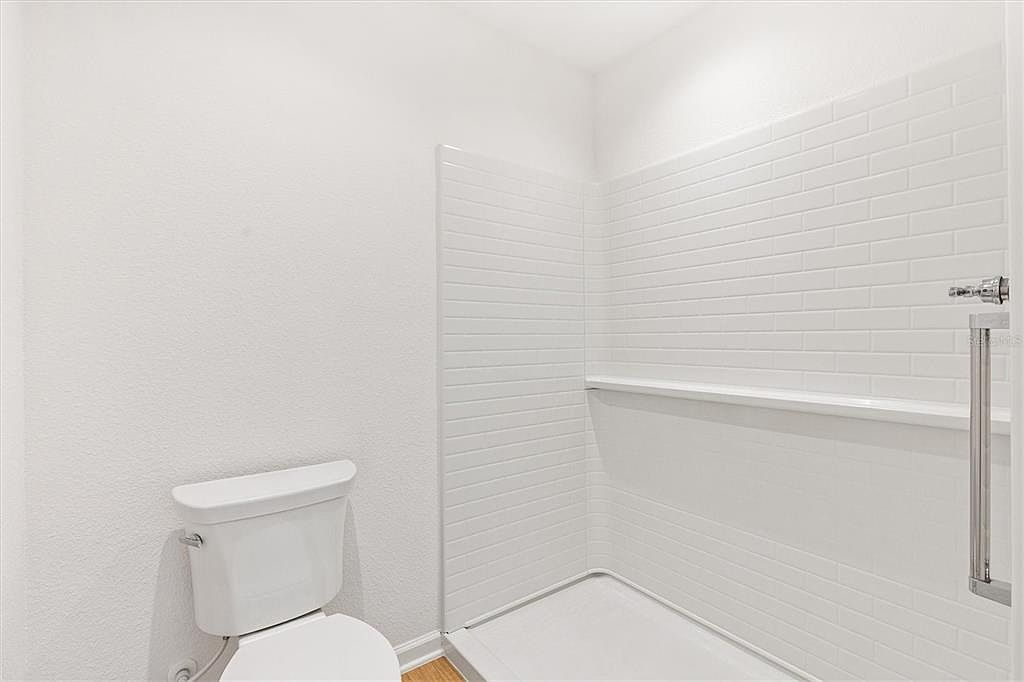 Bathroom with walk-in shower and subway tile surround