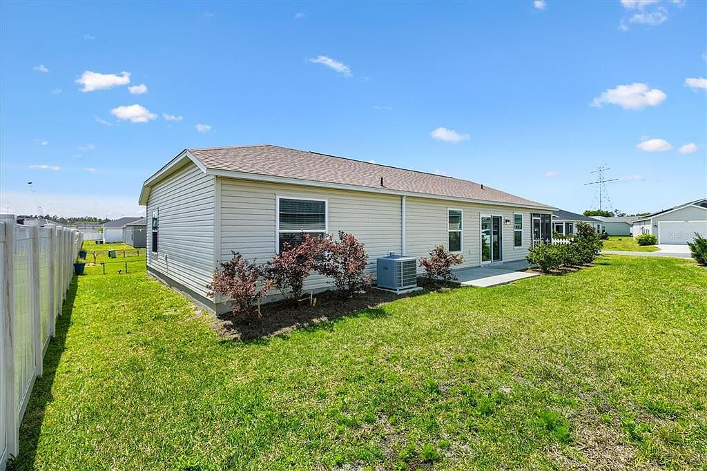 Rear exterior of 7185 Fay Ct showing the full fenced backyard and Topaz patio villa
