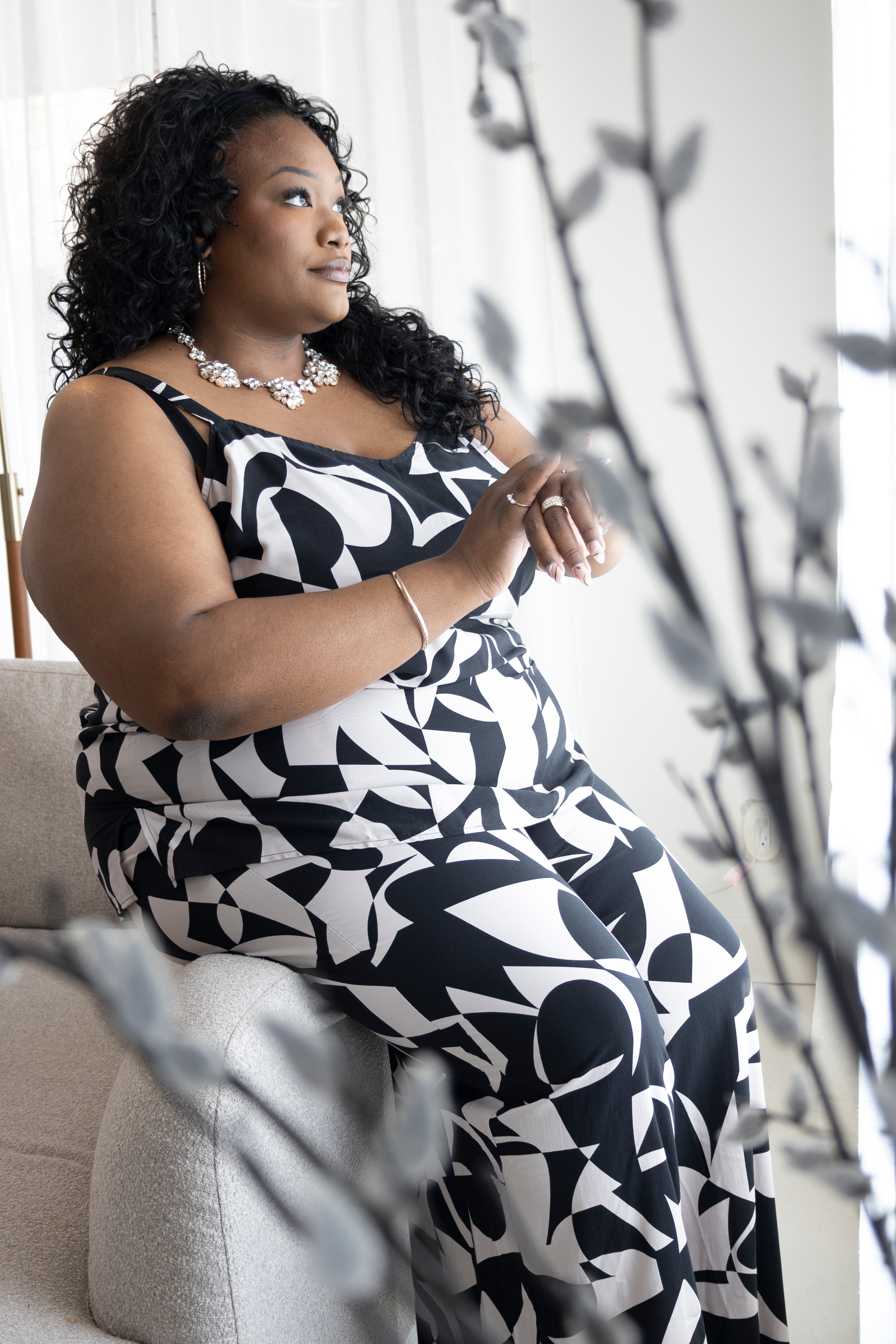 Tory Akene lifestyle portrait sitting on a sofa