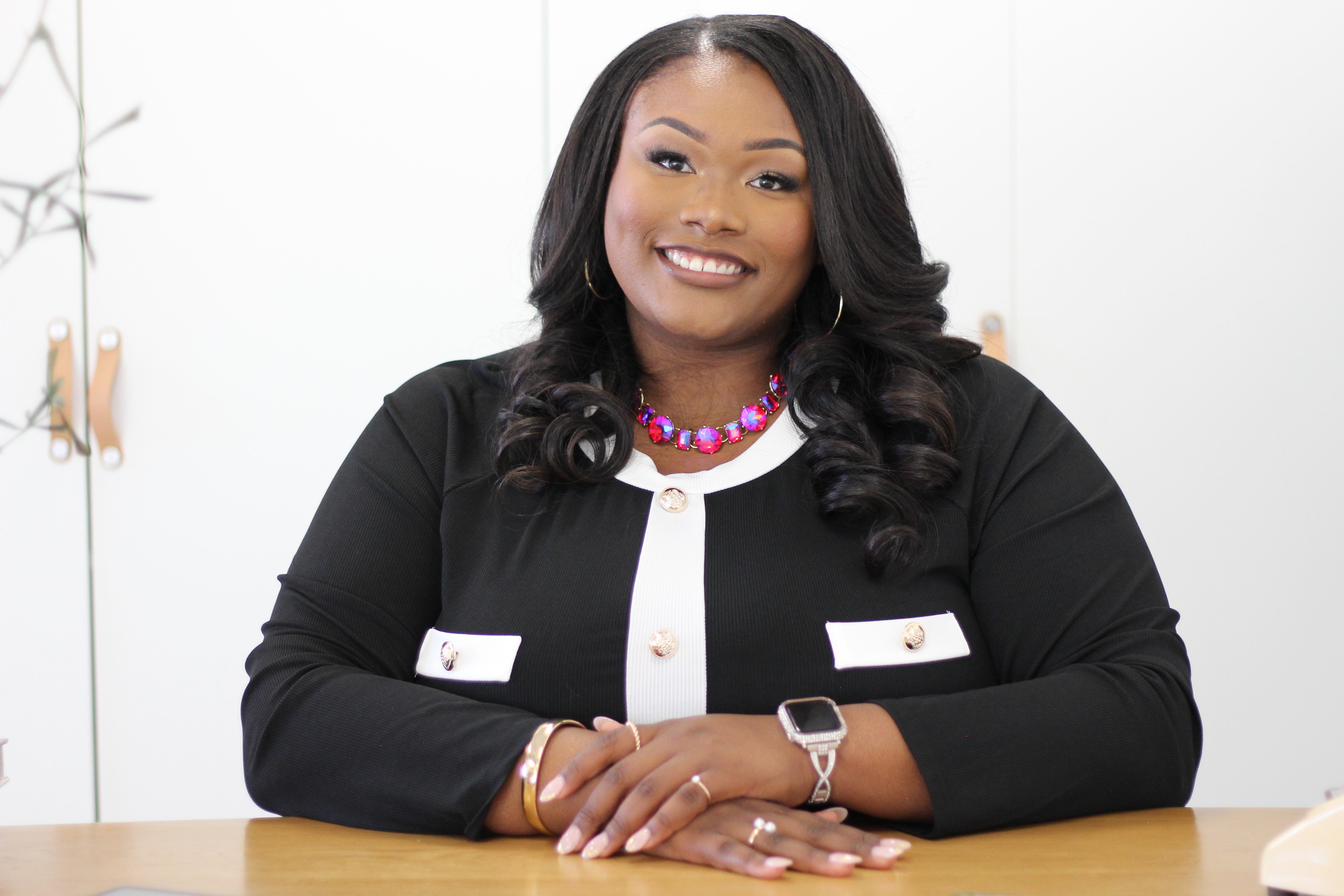 Tory Akene professional headshot at desk