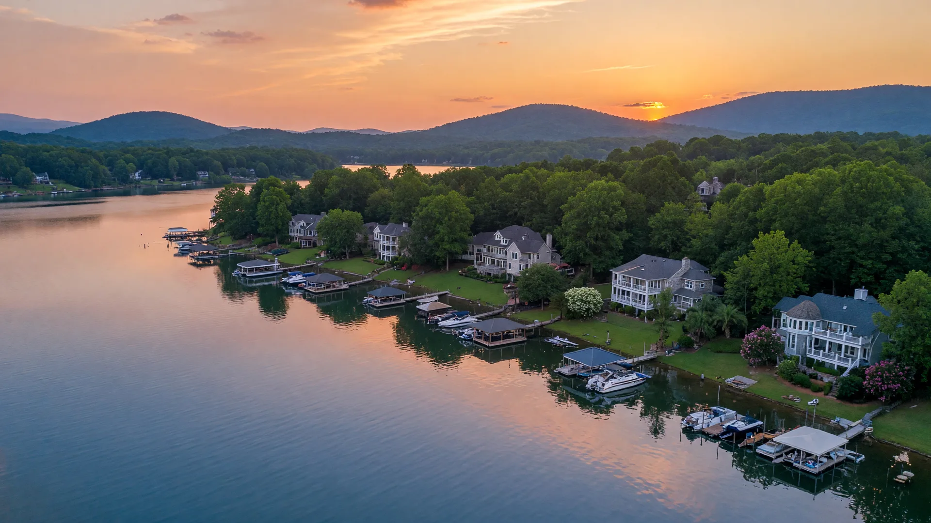 Lake Norman waterfront homes with private docks and tree-lined shores near Mooresville NC at golden hour