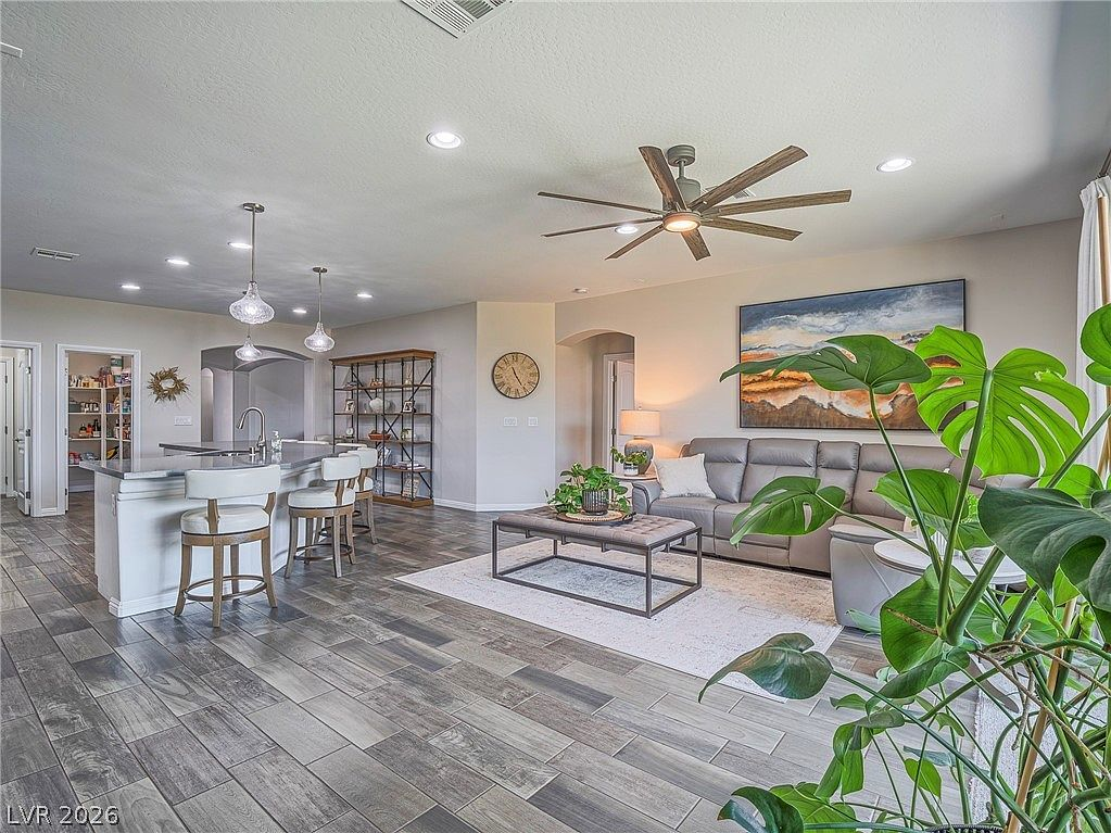 Open-concept living and kitchen with recessed lighting