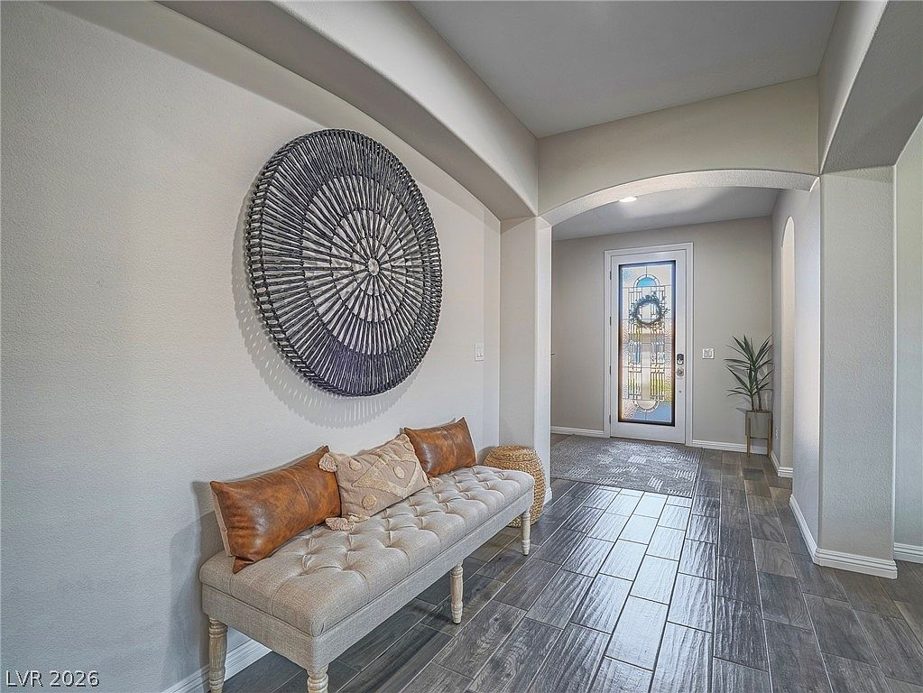 Interior entryway with ceramic tile flooring and arched frame
