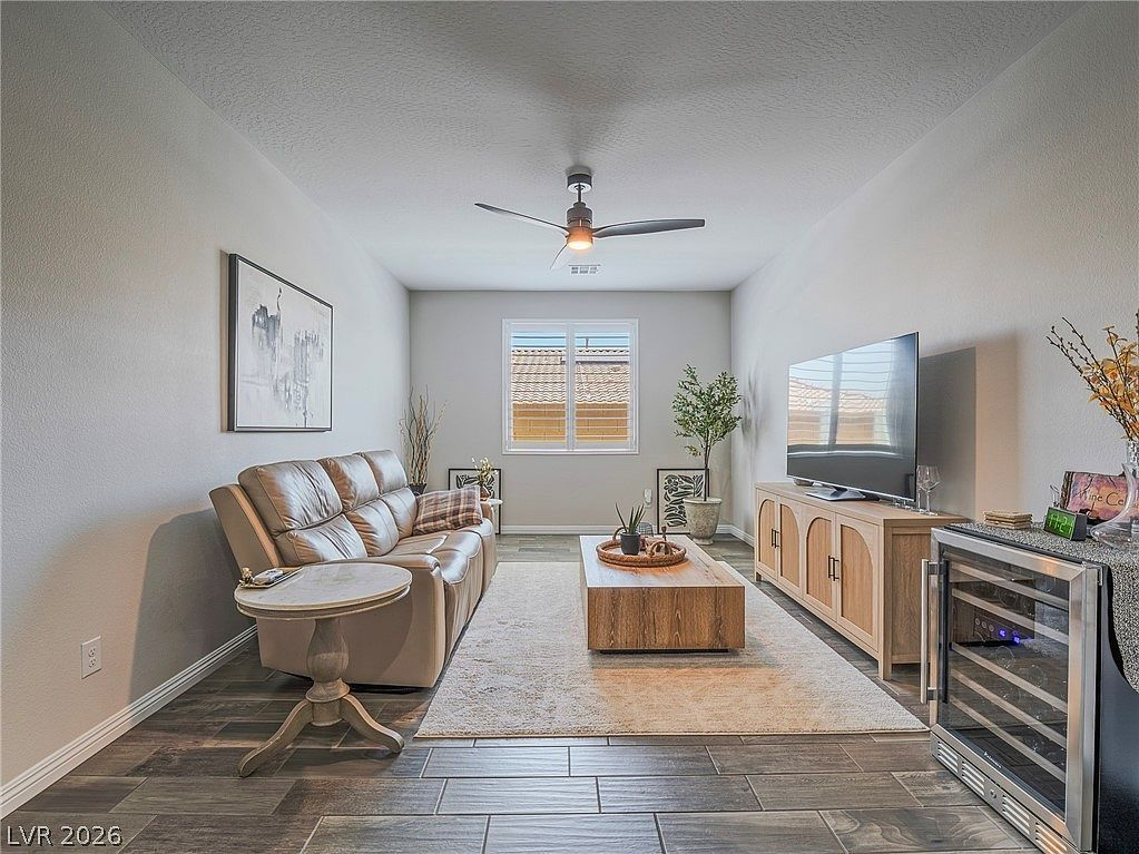 Living room with custom white shutters and neutral finishes