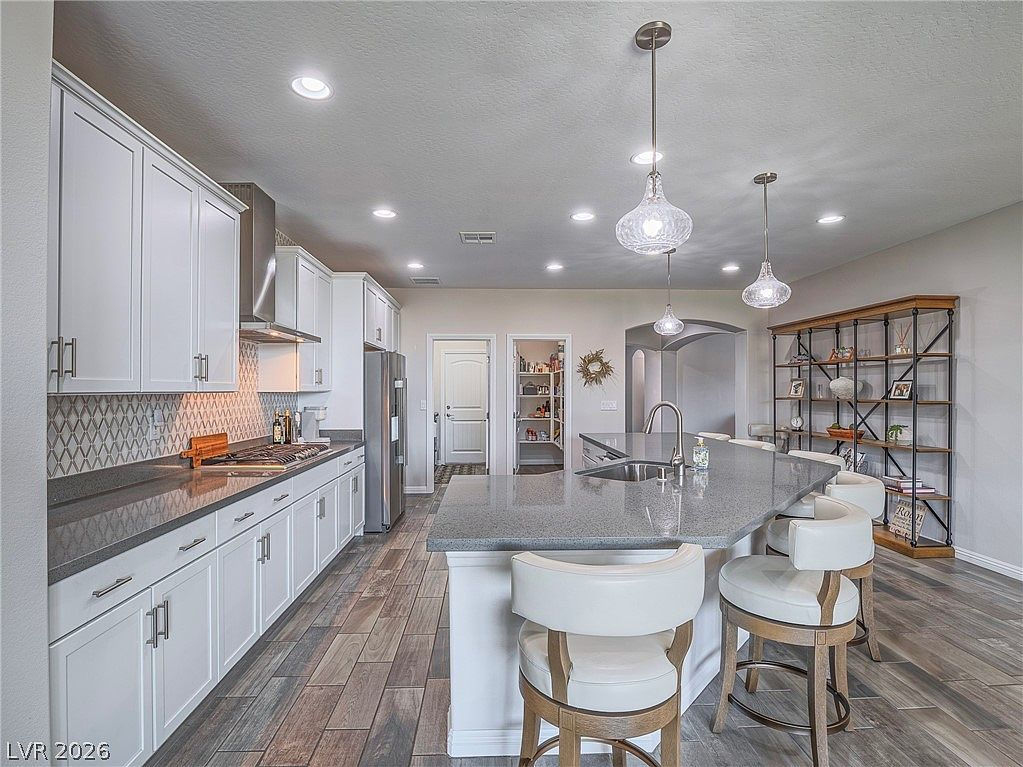 Modern white kitchen with soft-close cabinetry and geometric backsplash