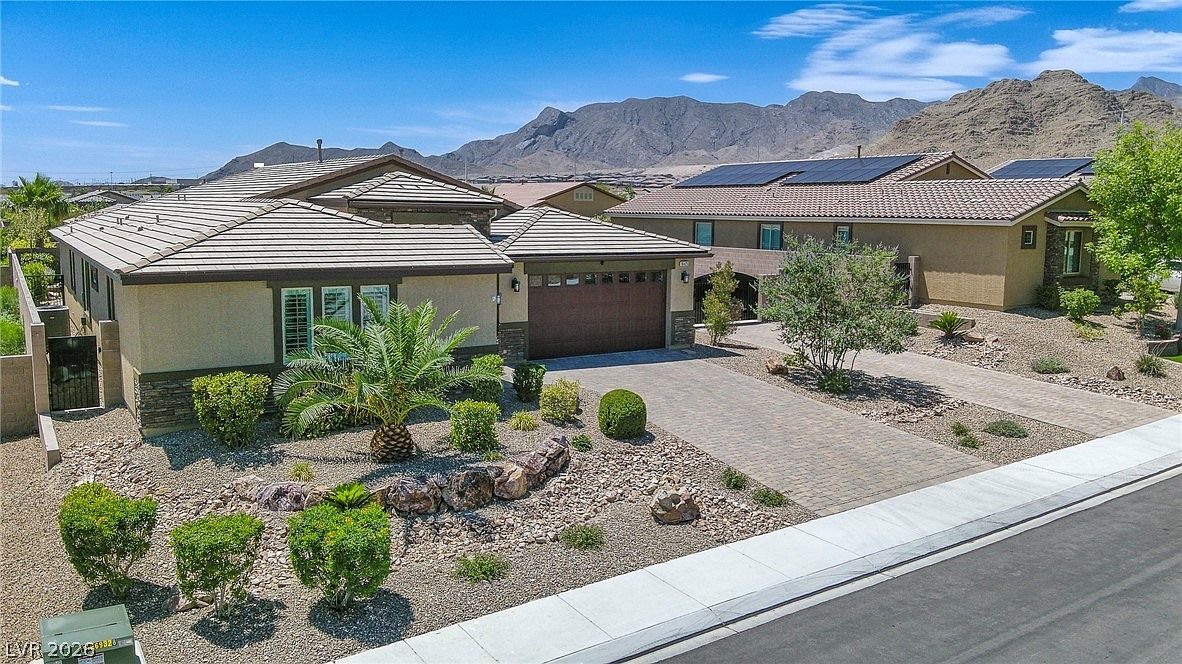 Elevated high-angle exterior shot with mountain backdrop and palm tree