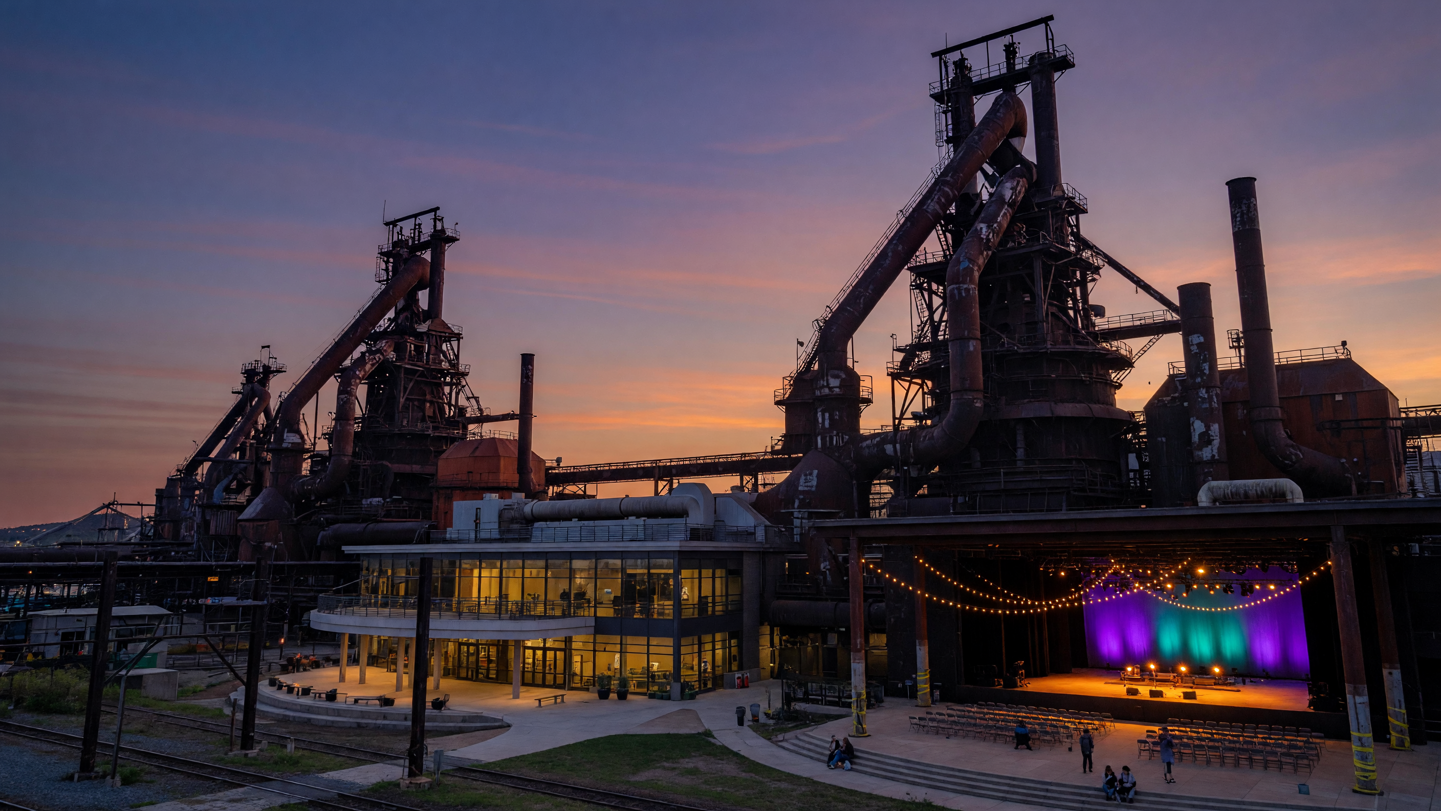 The iconic SteelStacks ArtsQuest campus in Bethlehem, Pennsylvania, with historic blast furnaces illuminated against a twilight sky