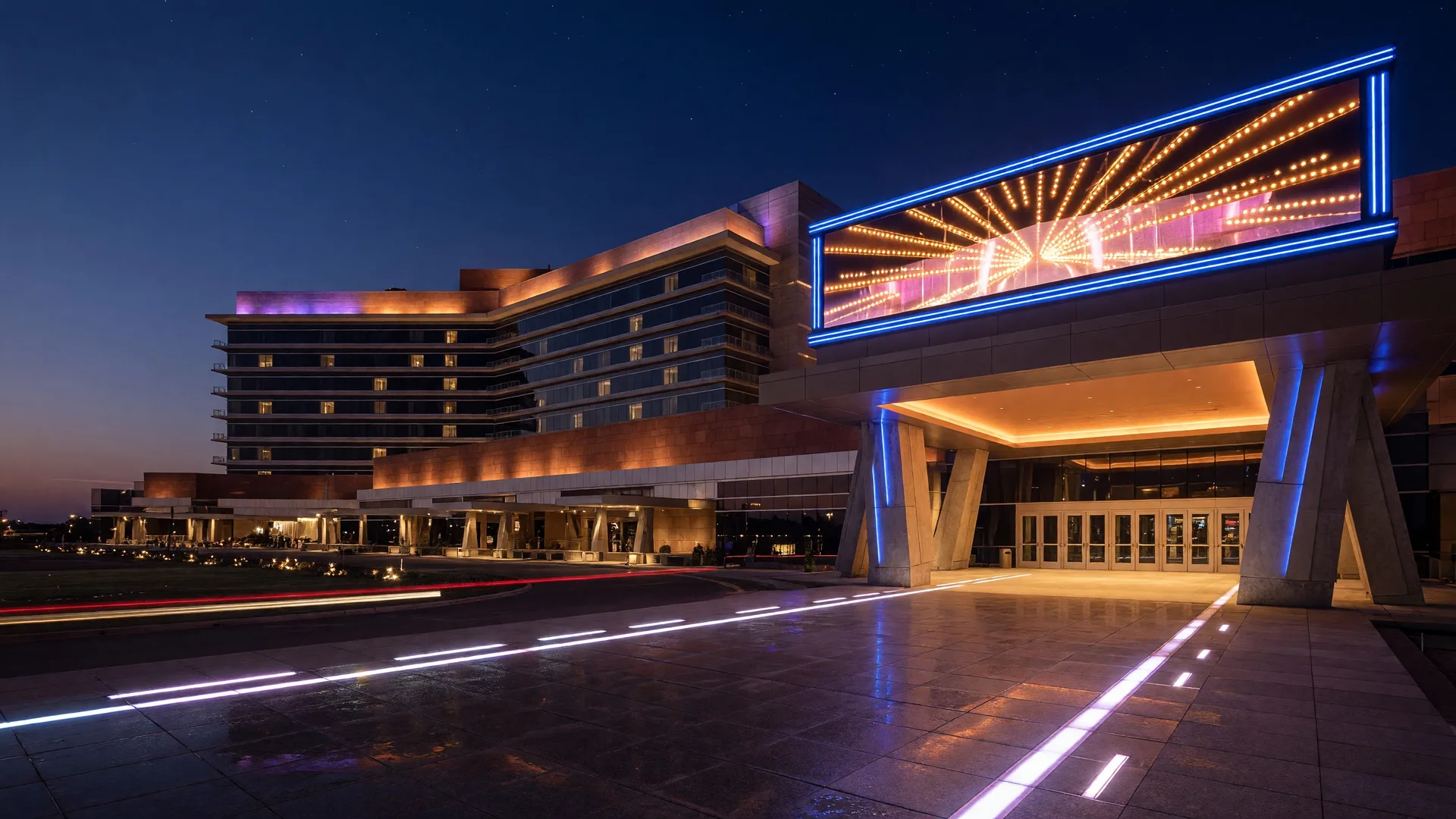 The Choctaw Casino and Resort exterior at night with the Grand Theater marquee illuminated