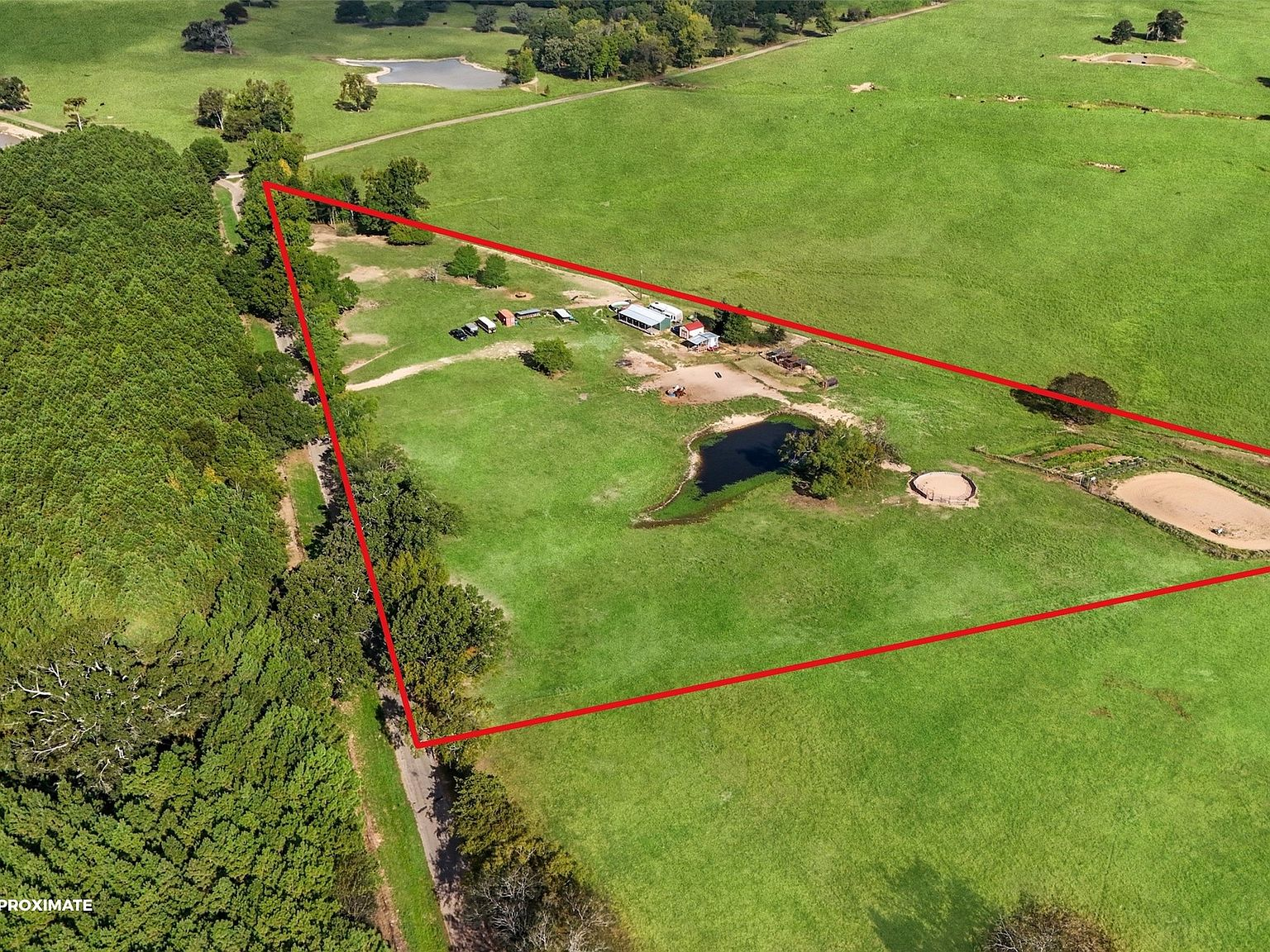 Wide aerial showing property parcel and structures