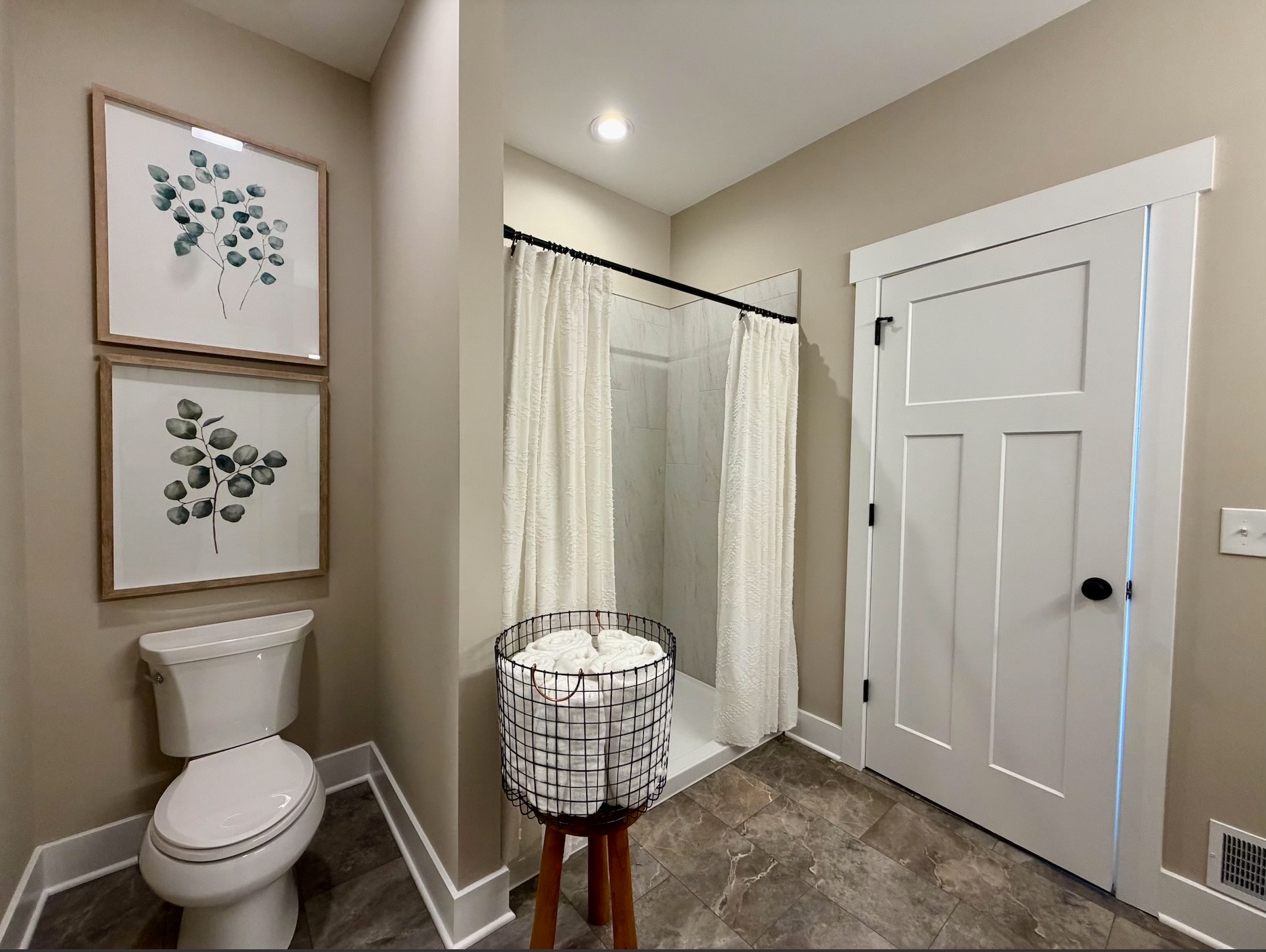 Staged Craftsman bathroom with walk-in tile shower and towel accents