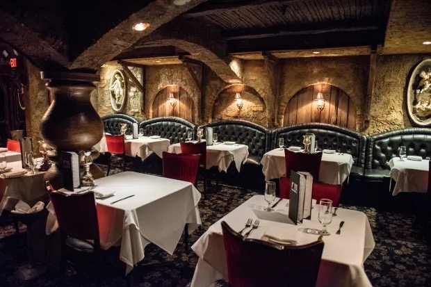The Cellar Restaurant dining room in Downtown Fullerton, candlelit stone arches and romantic ambiance