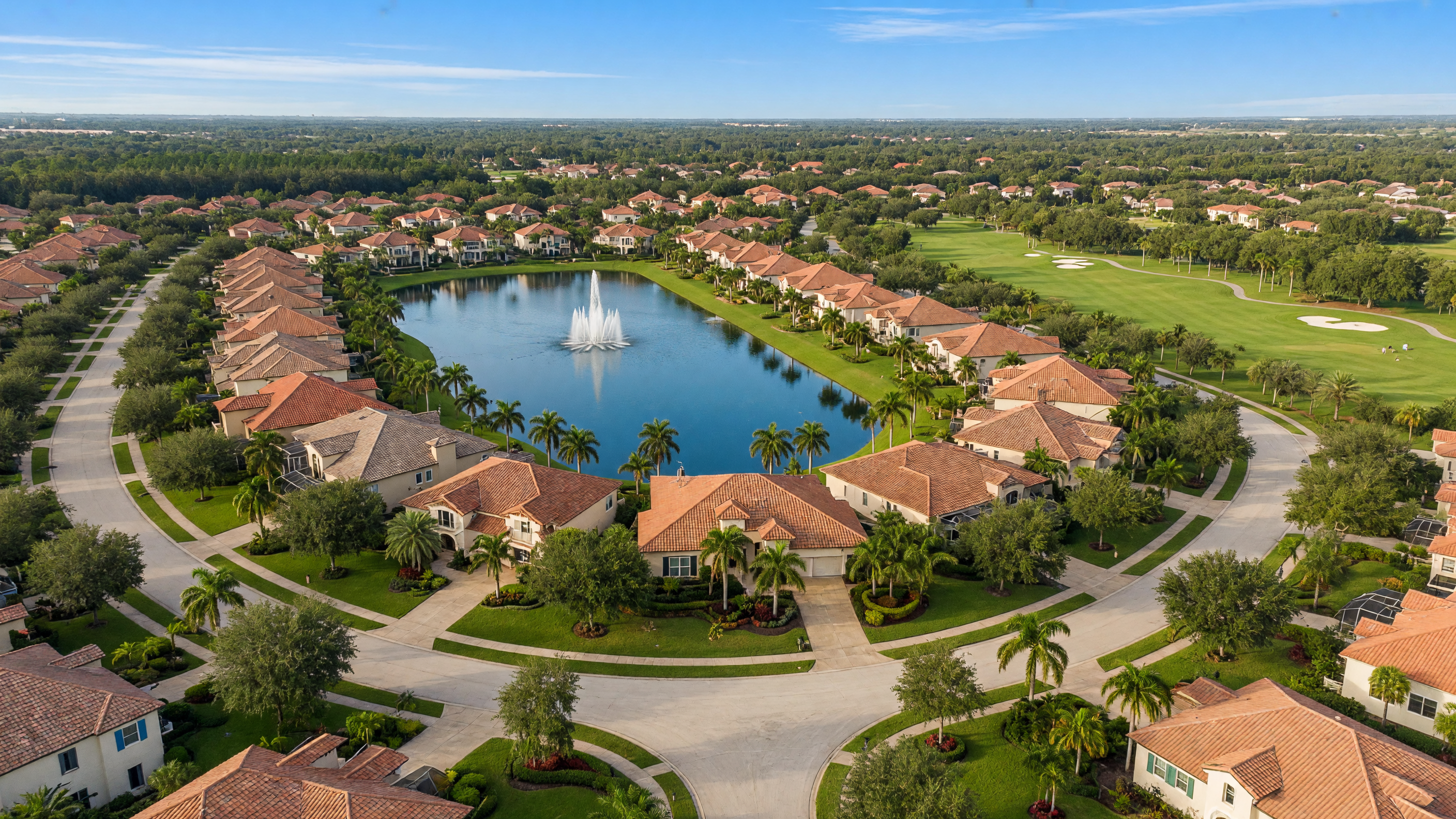 Aerial view of Lakewood Ranch master-planned community with tree-lined streets, lakes, and manicured landscaping