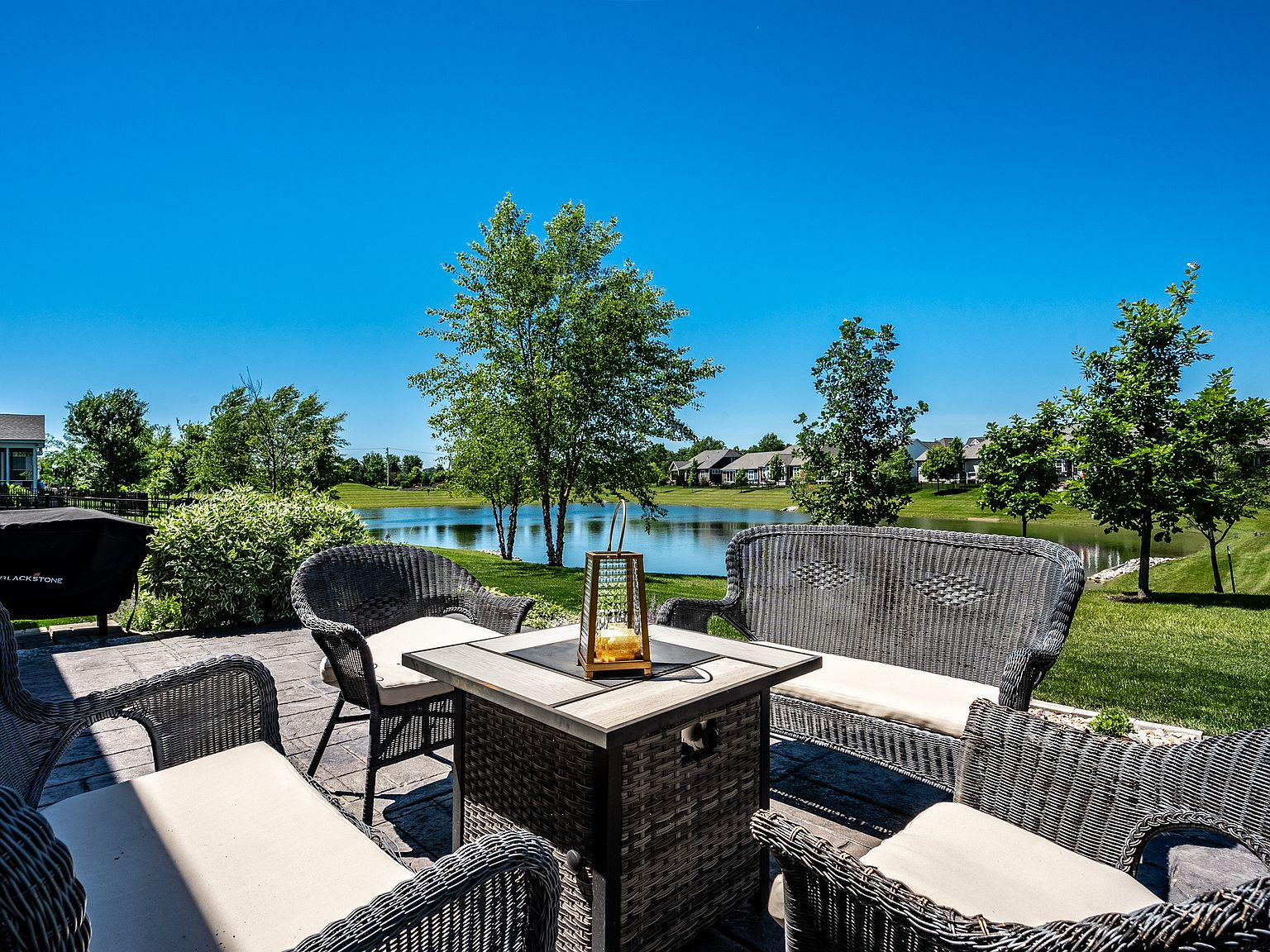 Stone patio overlooking a peaceful community pond