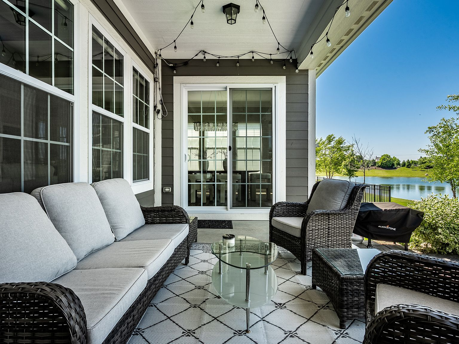 Covered patio overlooking the pond with glass sliding doors