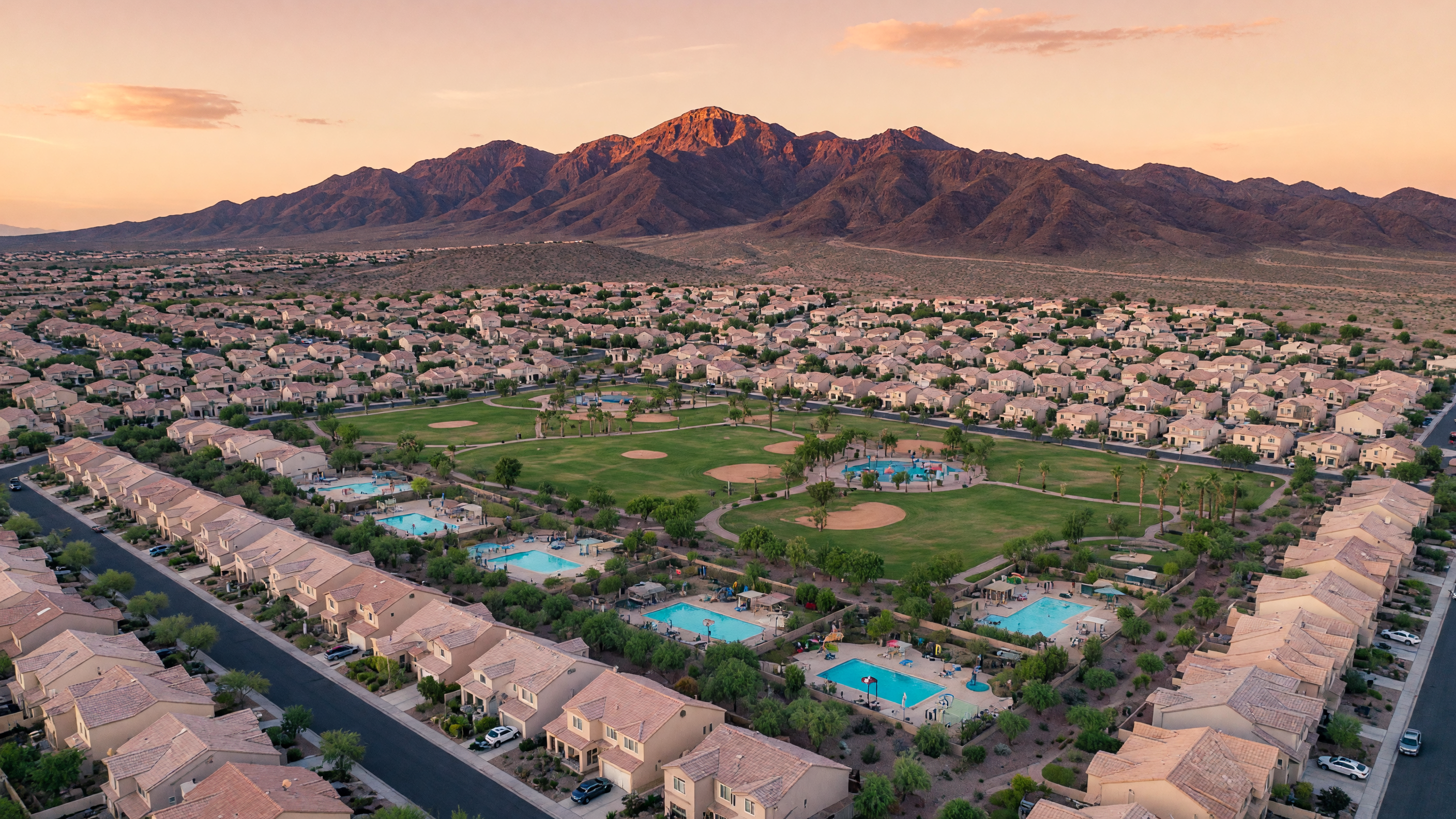 Aerial view of Henderson Nevada neighborhoods with mountains in the background and family-friendly communities with parks and tree-lined streets
