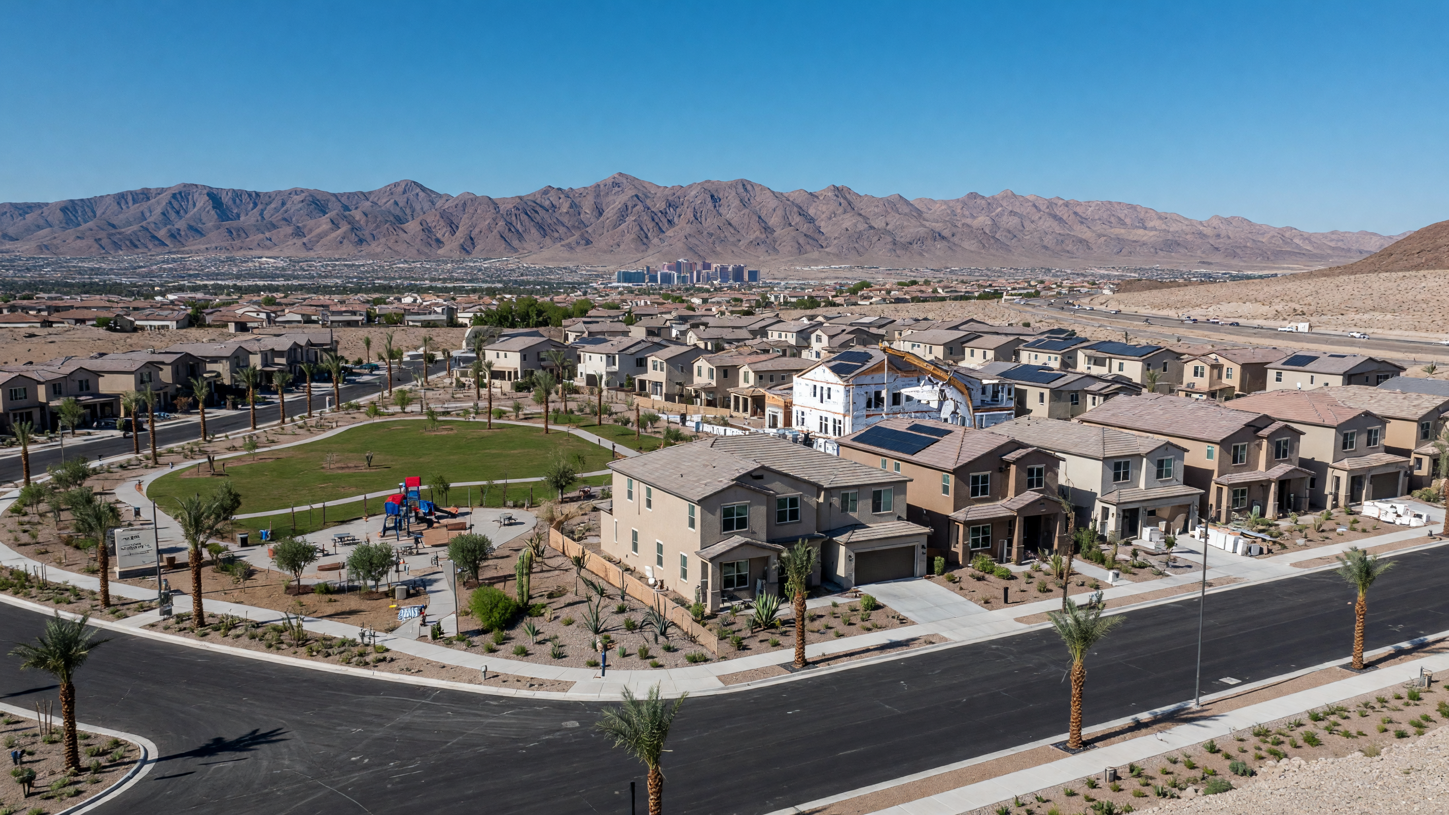 Southwest Las Vegas master-planned community with contemporary homes, palm-lined streets, community parks, and desert mountain backdrop