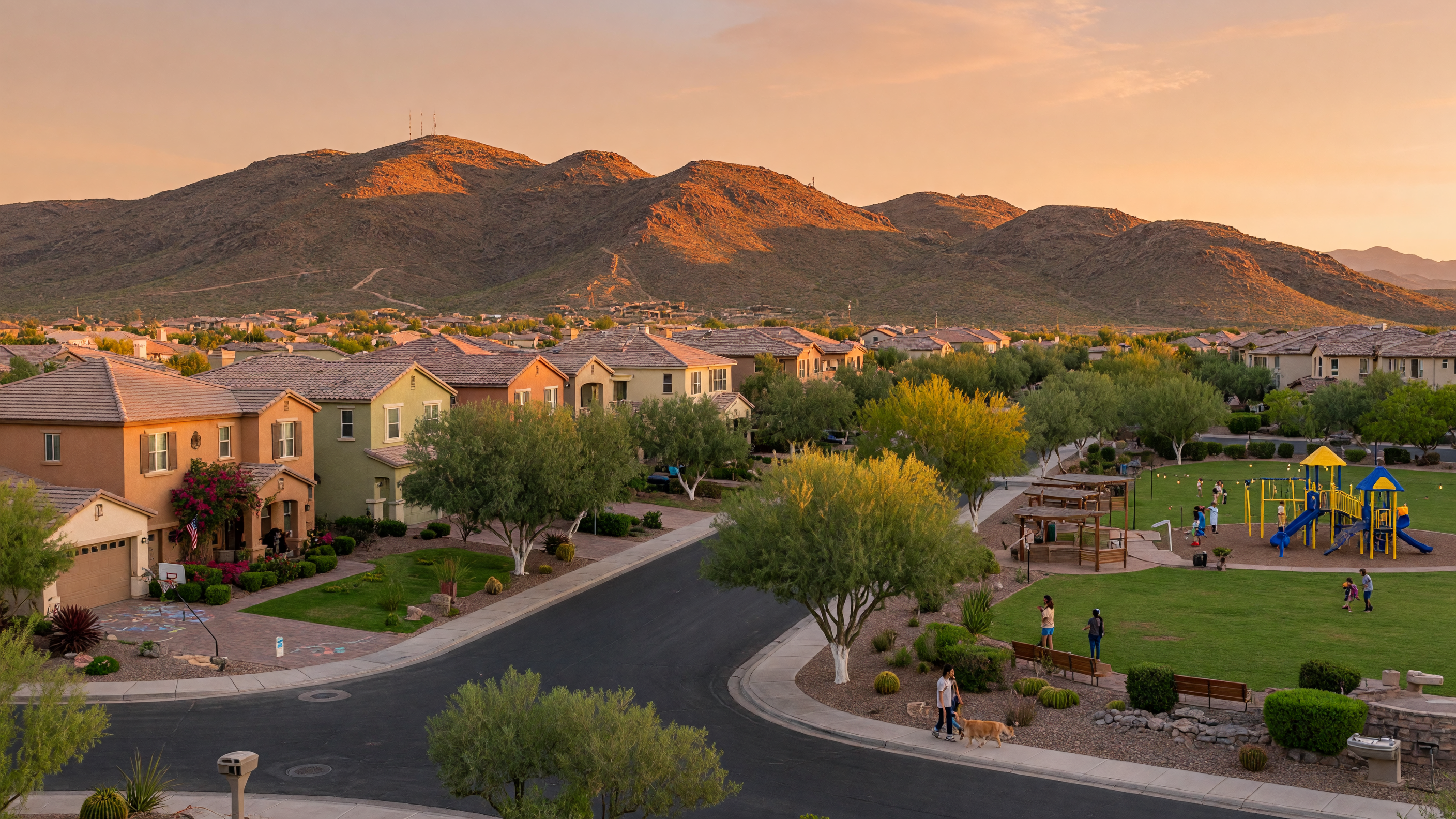 Henderson Nevada neighborhood at golden hour with tree-lined streets, family homes, parks, and Black Mountain foothills in the background