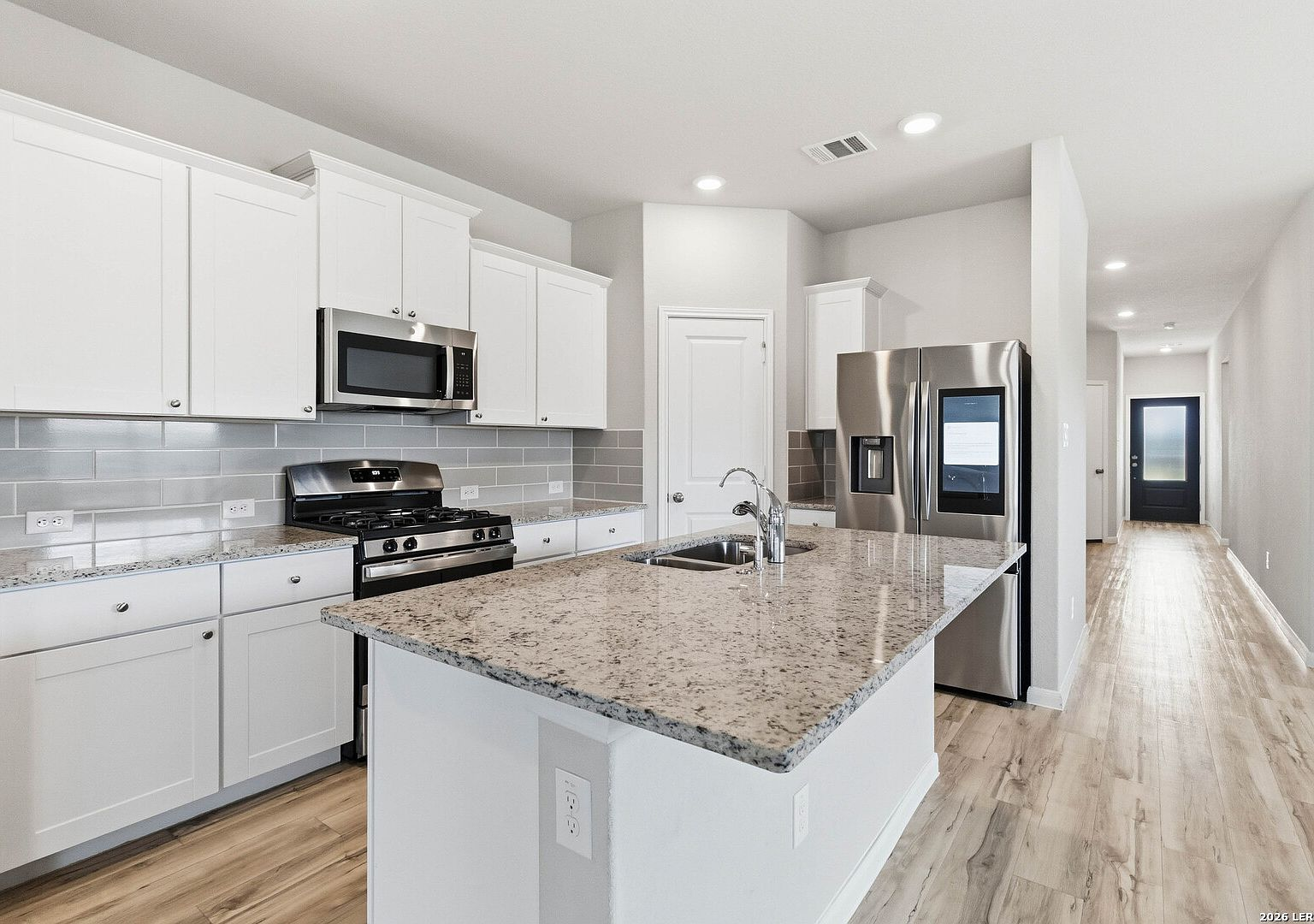 Kitchen island with granite countertops and stainless steel appliances