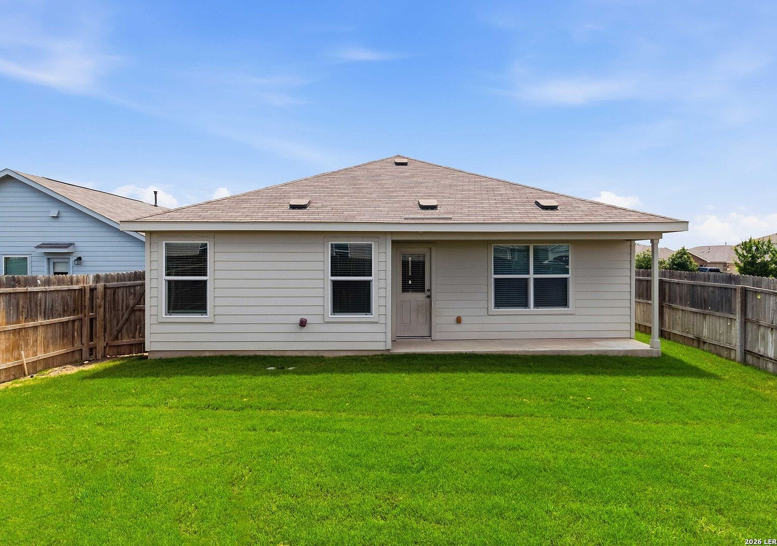 Backyard with covered porch and wood privacy fencing