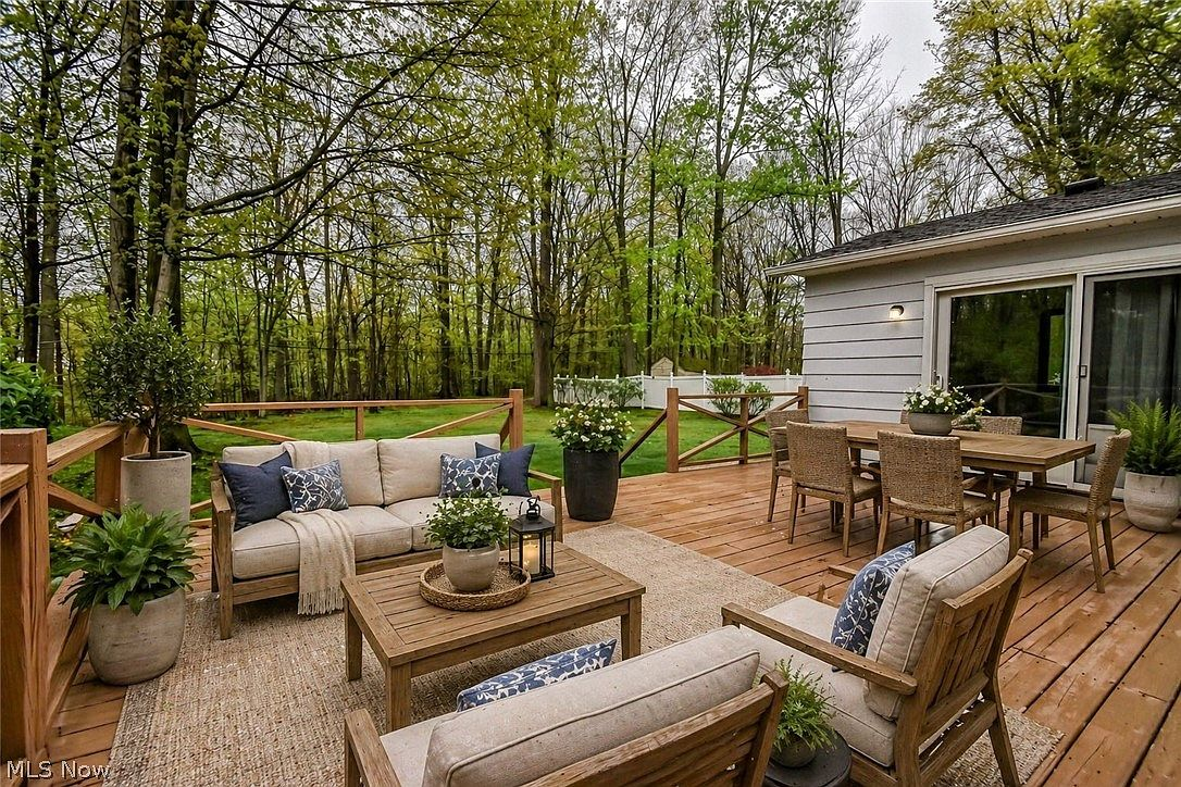 Raised wooden deck with forest backdrop and outdoor living space