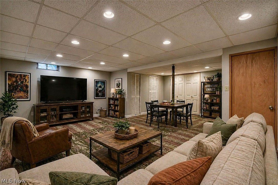 Finished basement recreation room with sectional sofa and media area