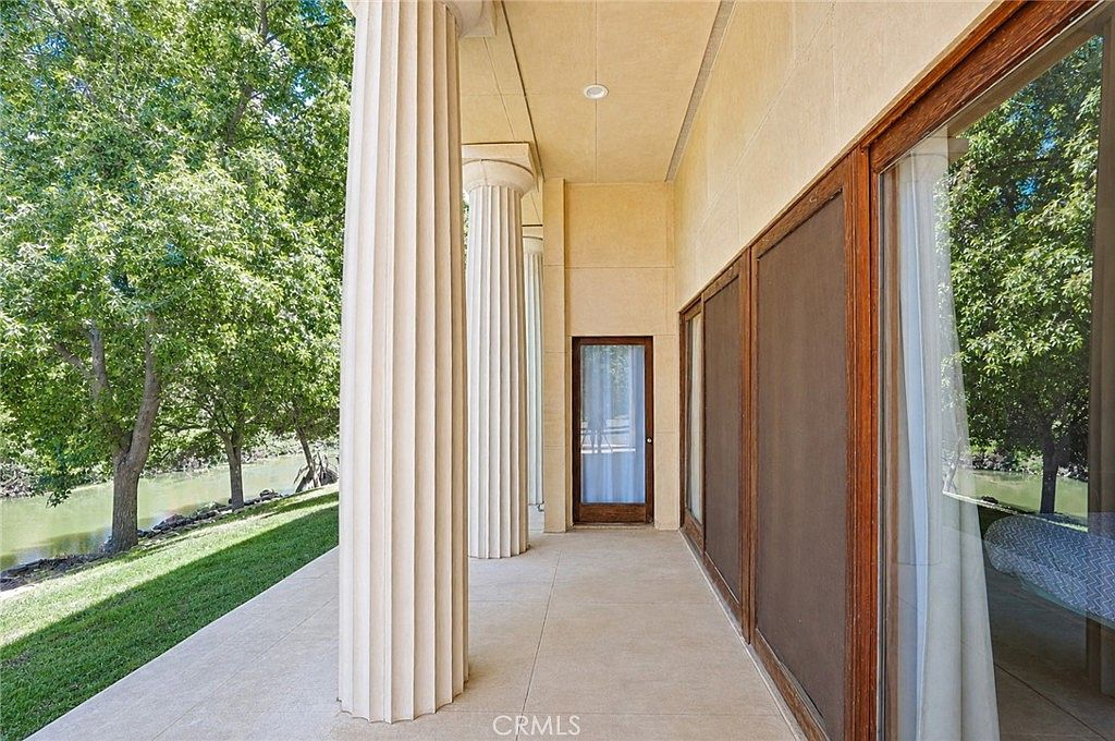 Covered creekside patio beneath the neoclassical porch