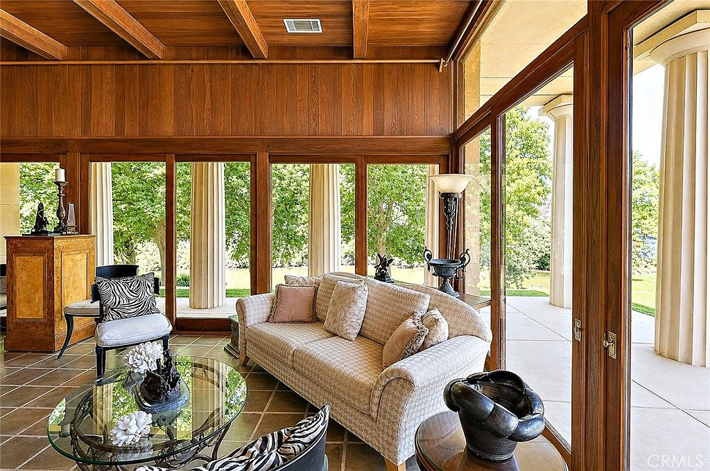 Living room with floor-to-ceiling windows overlooking Bear Creek