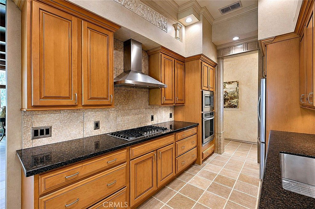 Galley view of the kitchen with wood cabinets