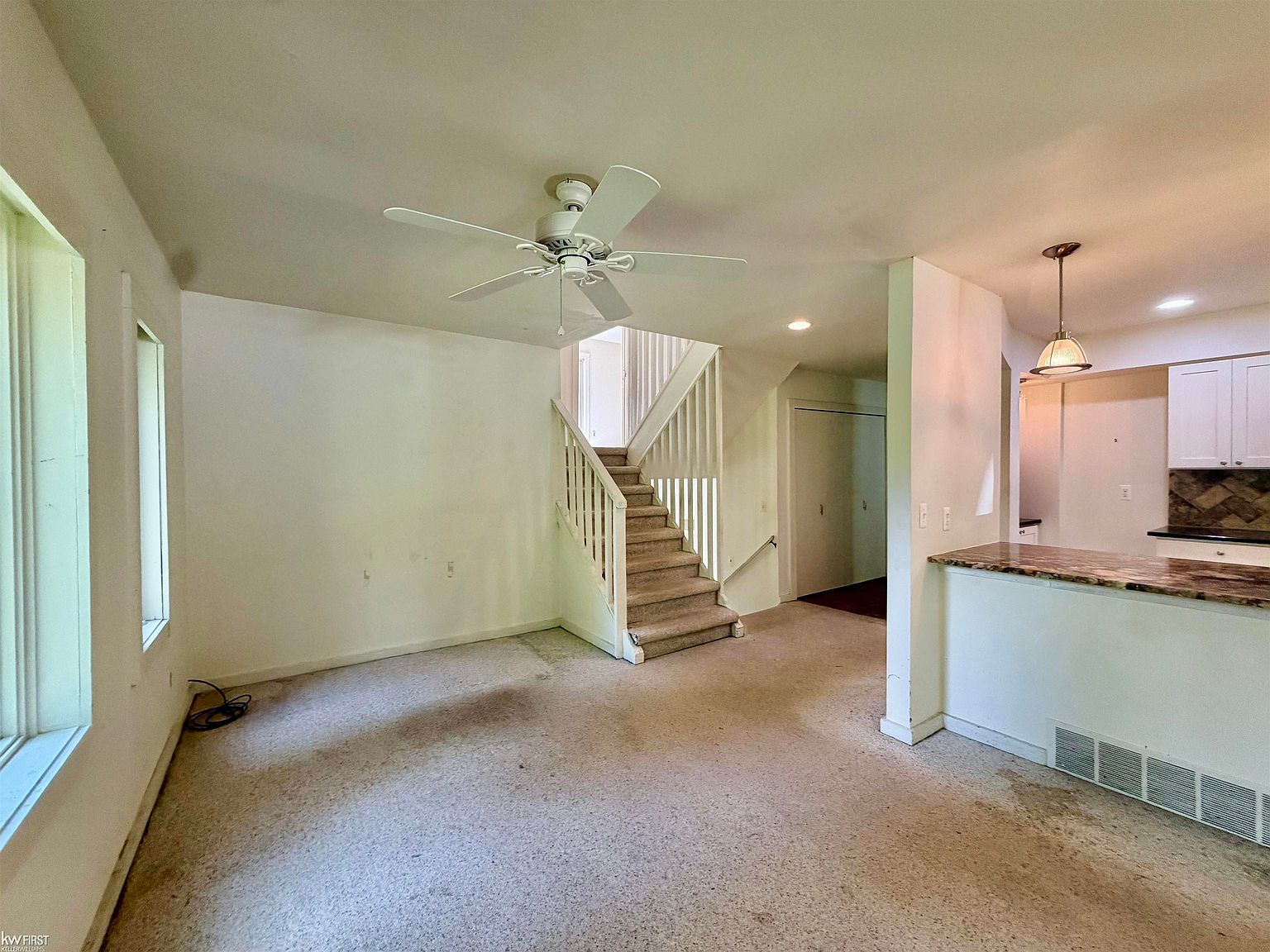 Living room and staircase view with natural daylight