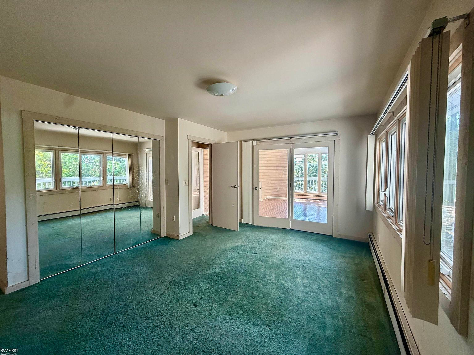 Primary bedroom suite with sliding patio doors and natural light