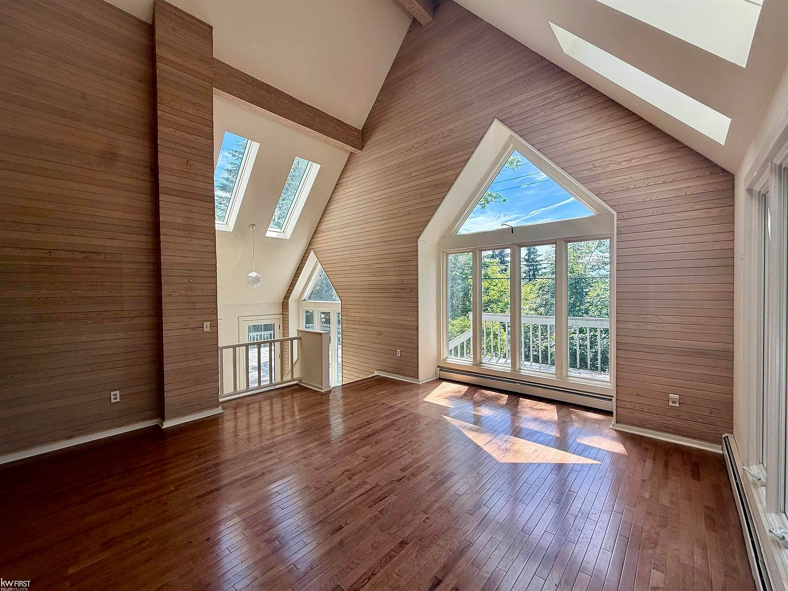 Great room with vaulted ceilings and panoramic lake views