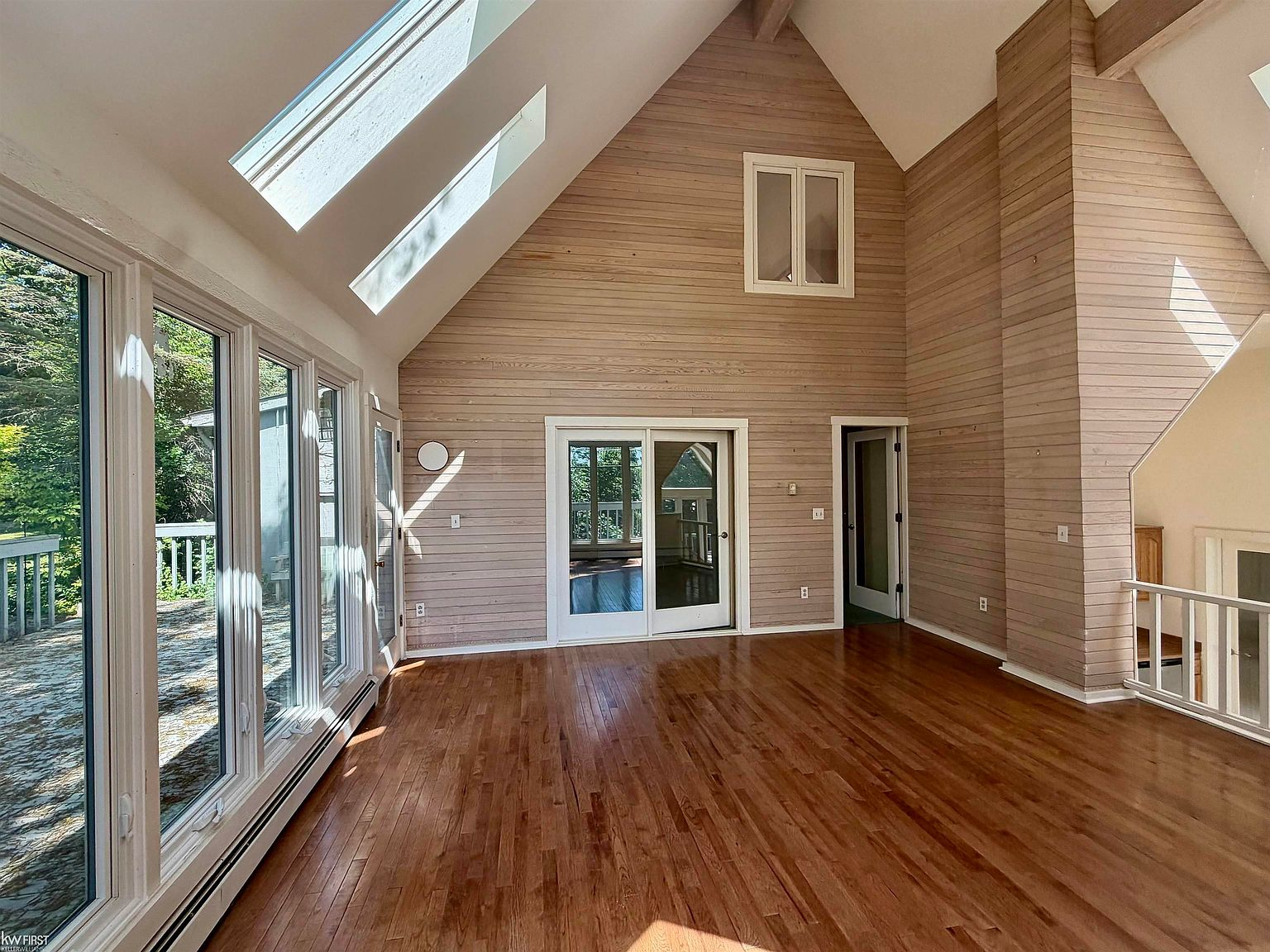 Great room with vaulted ceiling and hardwood floors