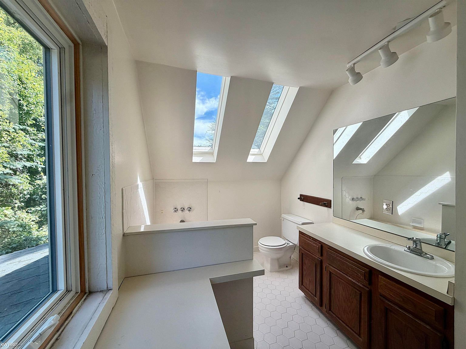 Bathroom with skylight and hexagonal floor tile